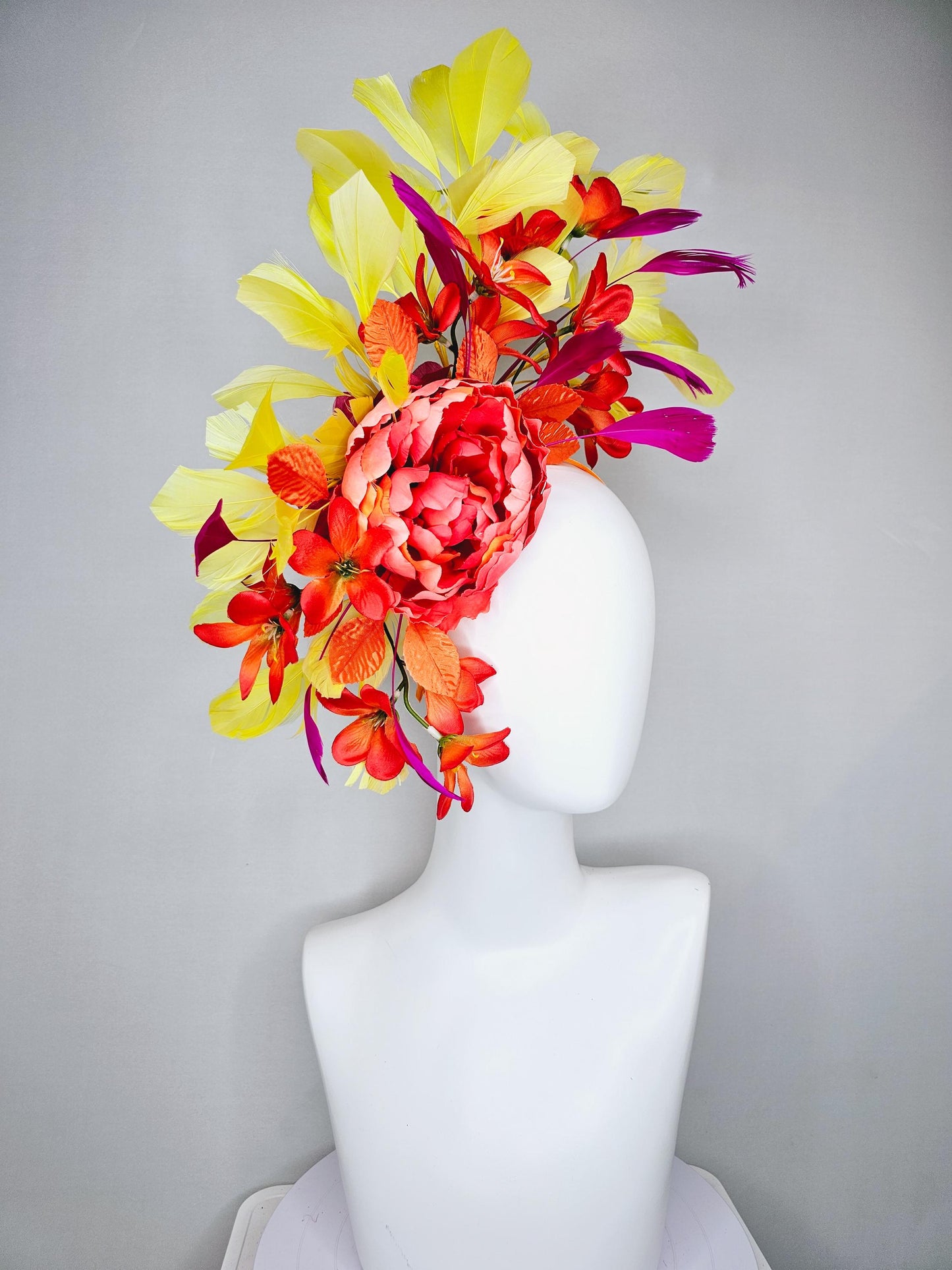 kentucky derby hat fascinator coral orange silk satin flowers with orange satin leaves, yellow and pink branching feathers on thin headband