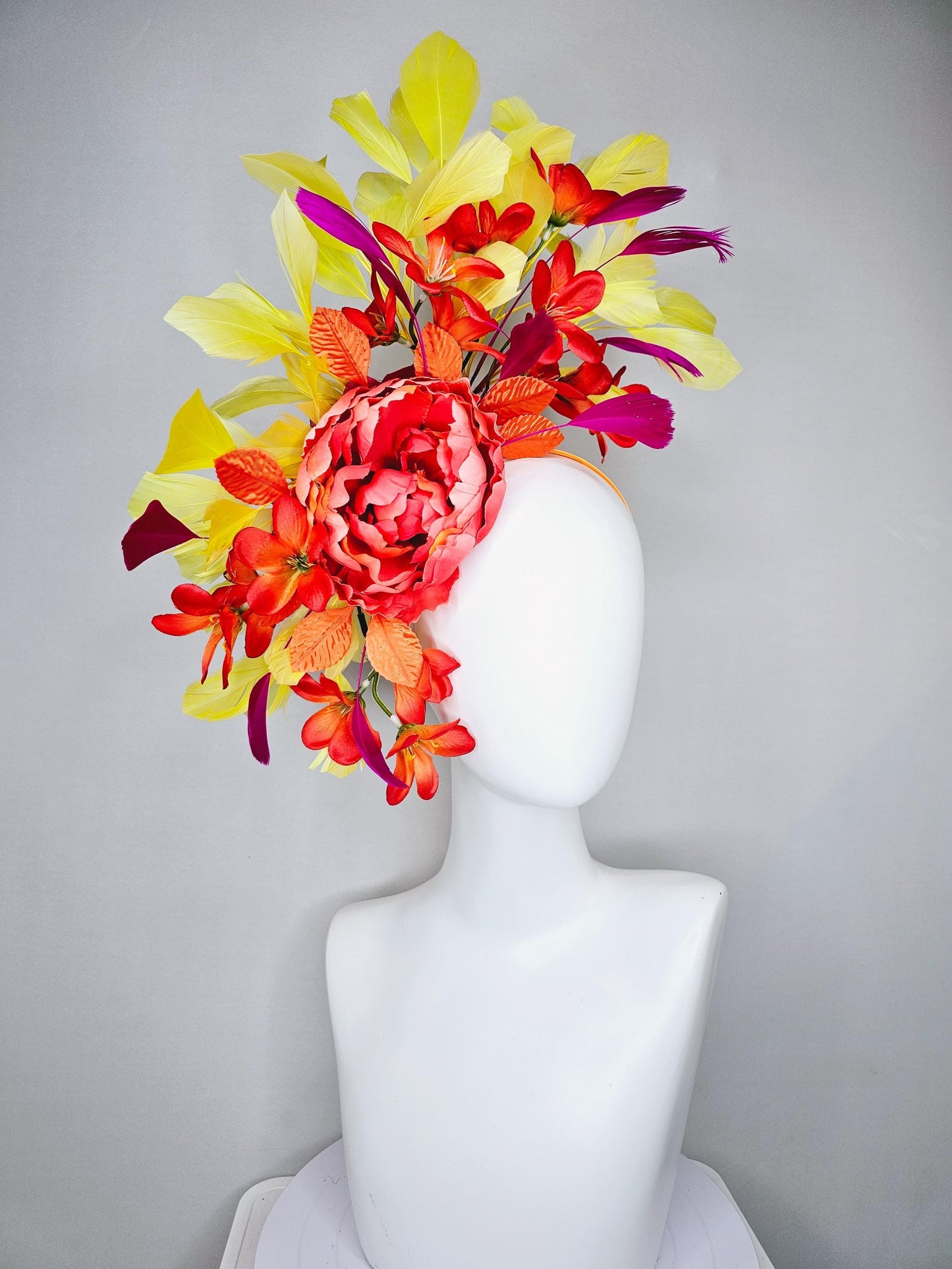 kentucky derby hat fascinator coral orange silk satin flowers with orange satin leaves, yellow and pink branching feathers on thin headband