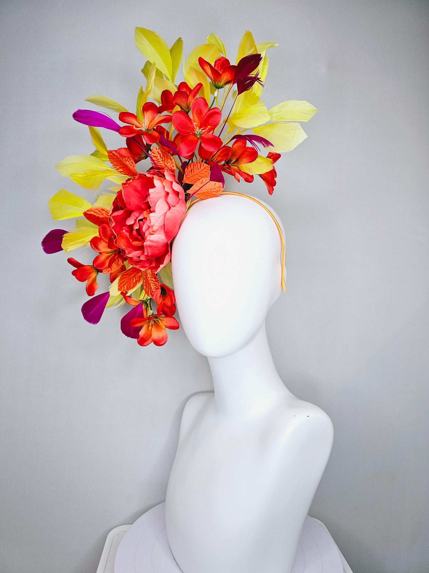 kentucky derby hat fascinator coral orange silk satin flowers with orange satin leaves, yellow and pink branching feathers on thin headband