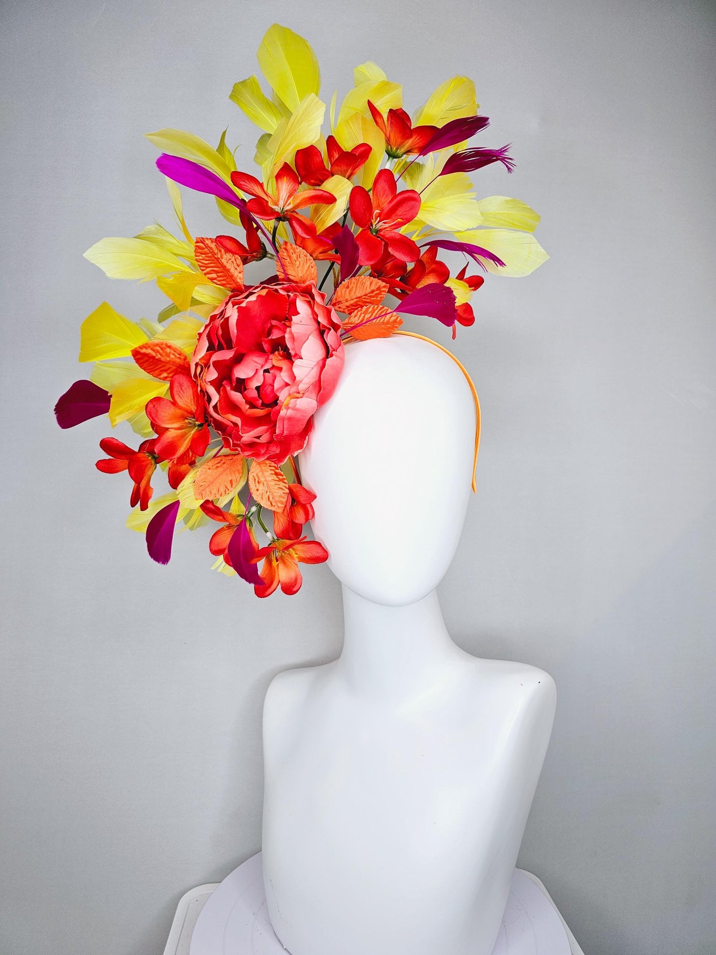 kentucky derby hat fascinator coral orange silk satin flowers with orange satin leaves, yellow and pink branching feathers on thin headband