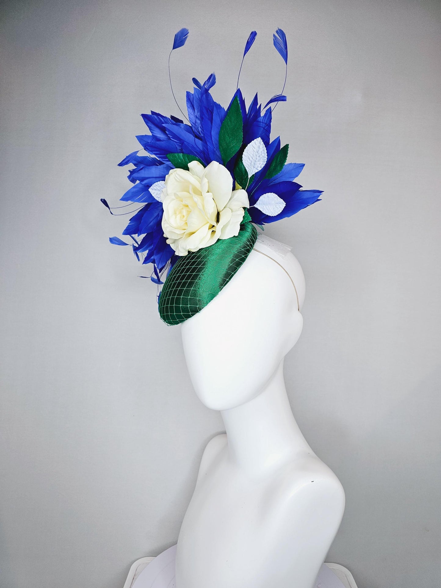 kentucky derby hat fascinator green satin with netting,white ivory satin rose flower,green leaves,royal cobalt blue branching feathers