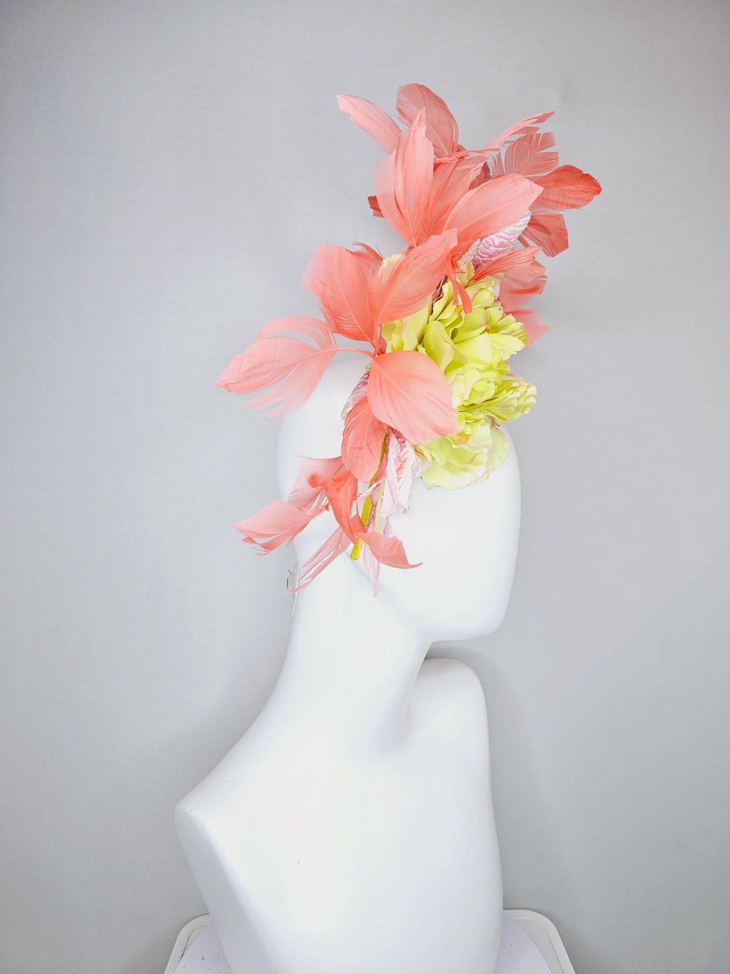 kentucky derby hat fascinator with yellow satin silk flower and light blush pink leaves, orange coral feathers on thin headband