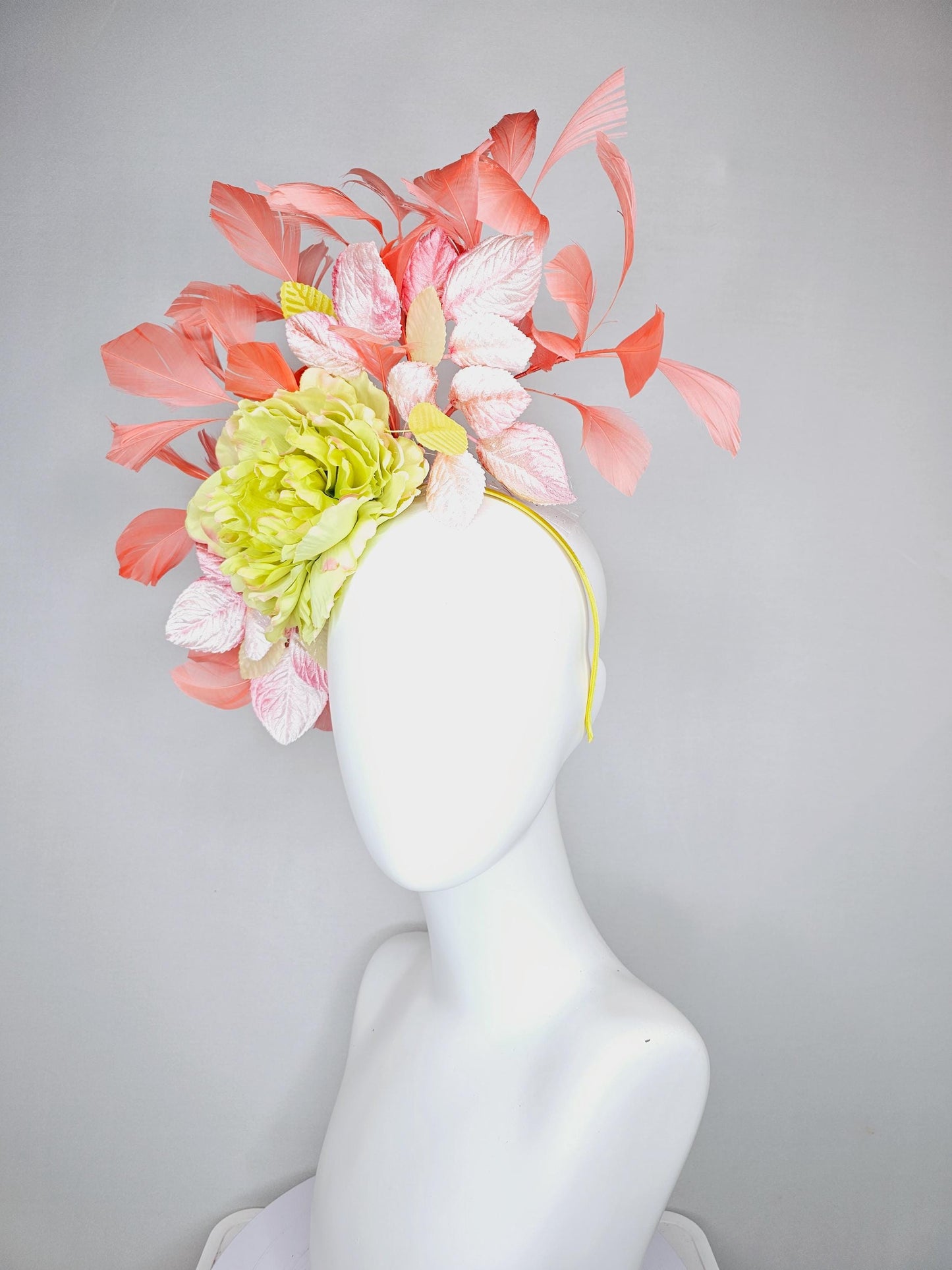 kentucky derby hat fascinator with yellow satin silk flower and light blush pink leaves, orange coral feathers on thin headband