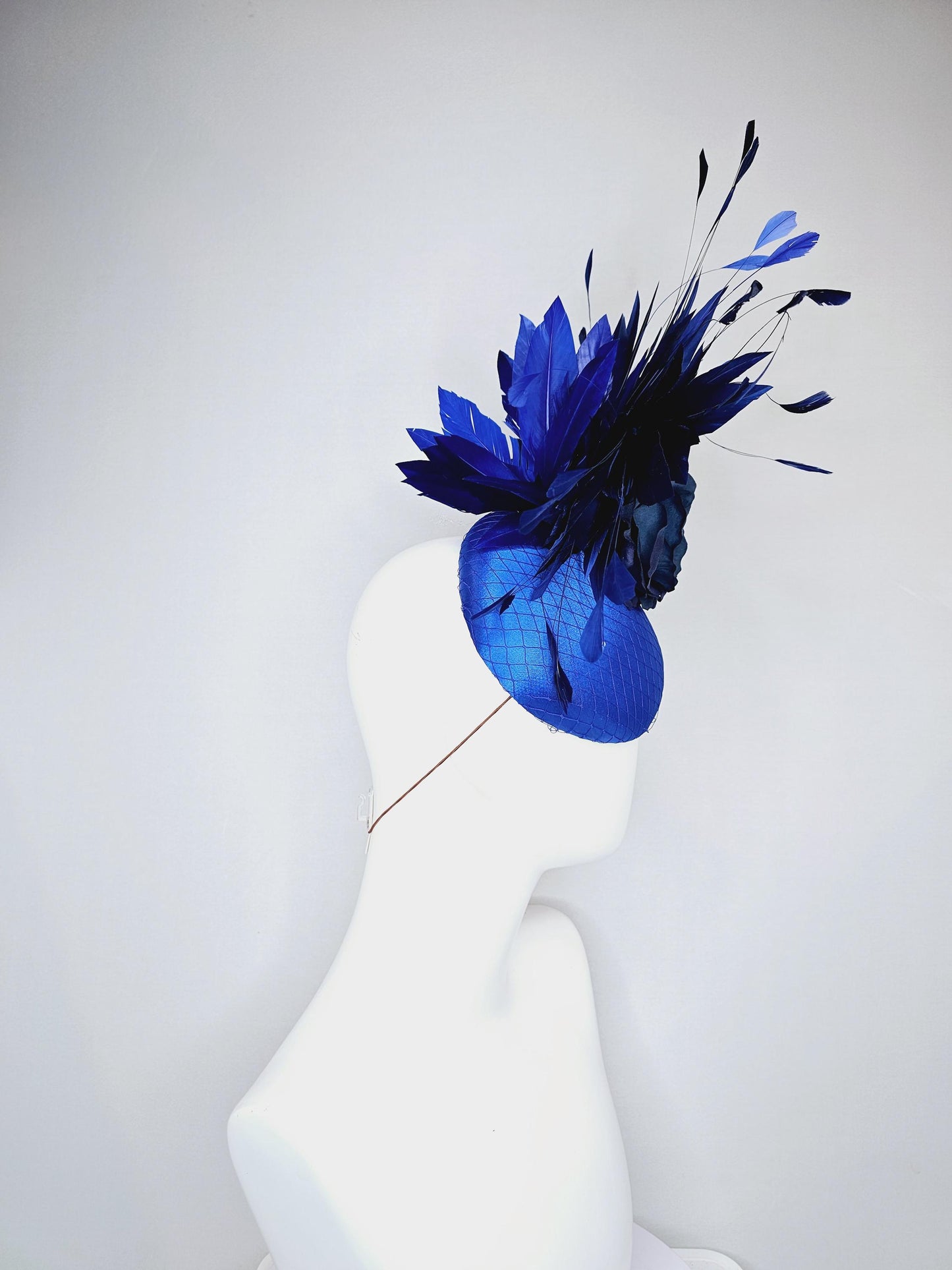 kentucky derby hat fascinator royal blue satin with netting,navy blue rose flower,cobalt blue leaves,navy royal blue branching feathers