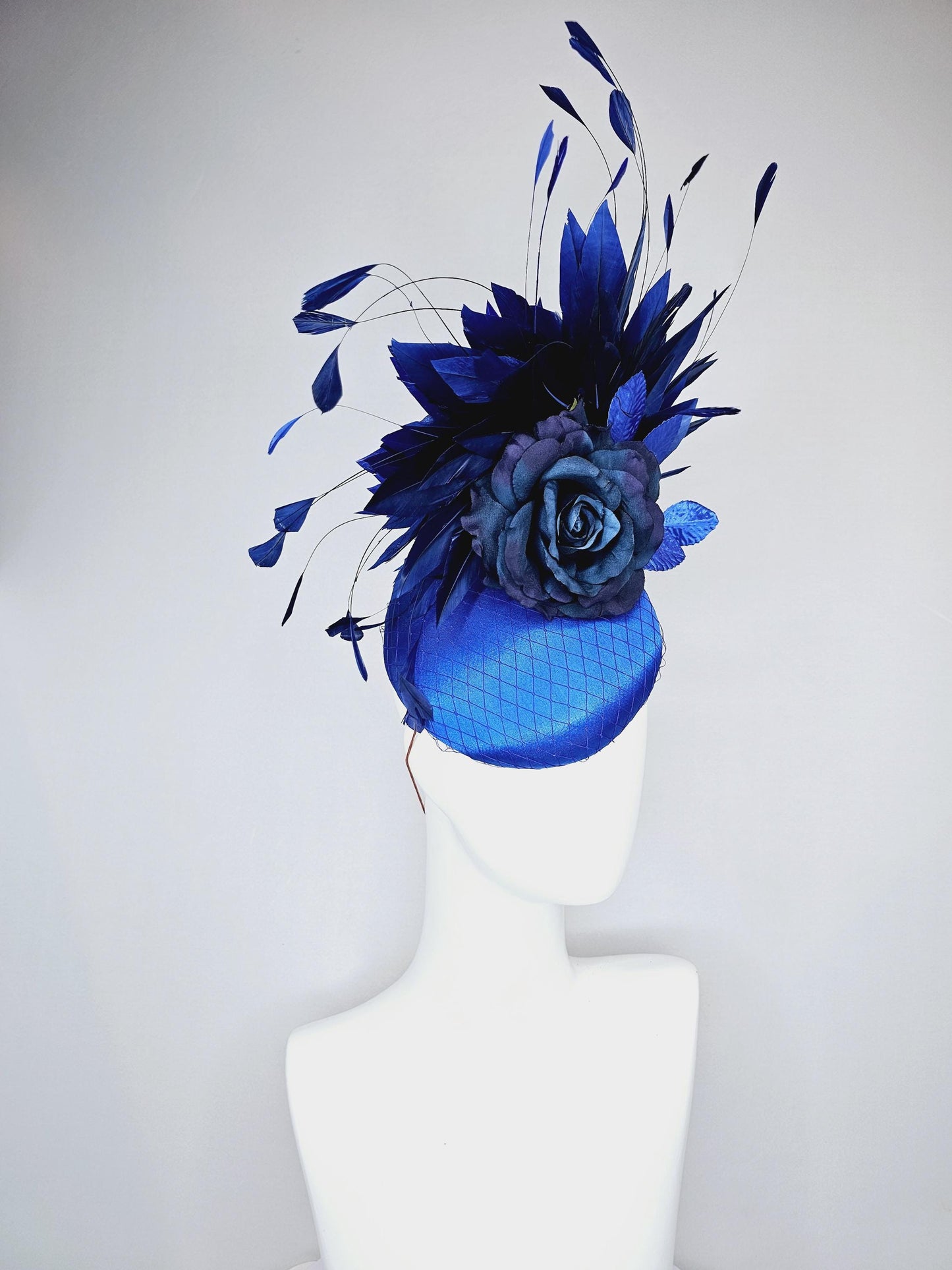 kentucky derby hat fascinator royal blue satin with netting,navy blue rose flower,cobalt blue leaves,navy royal blue branching feathers