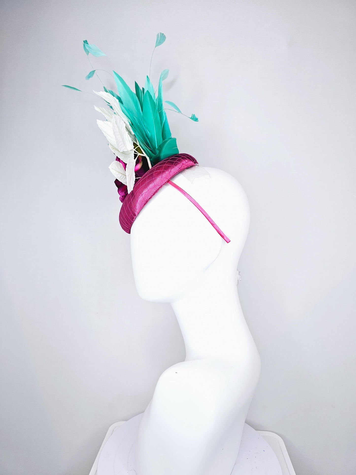 kentucky derby hat fascinator hot pink satin with netting,hot pink fuchsia satin silk rose flower,white leaves,aqua blue branching feathers