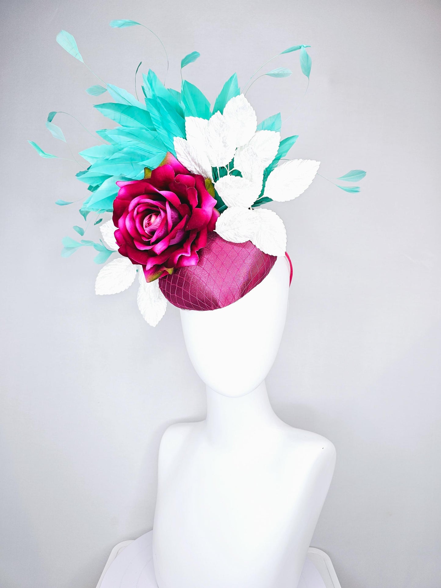 kentucky derby hat fascinator hot pink satin with netting,hot pink fuchsia satin silk rose flower,white leaves,aqua blue branching feathers