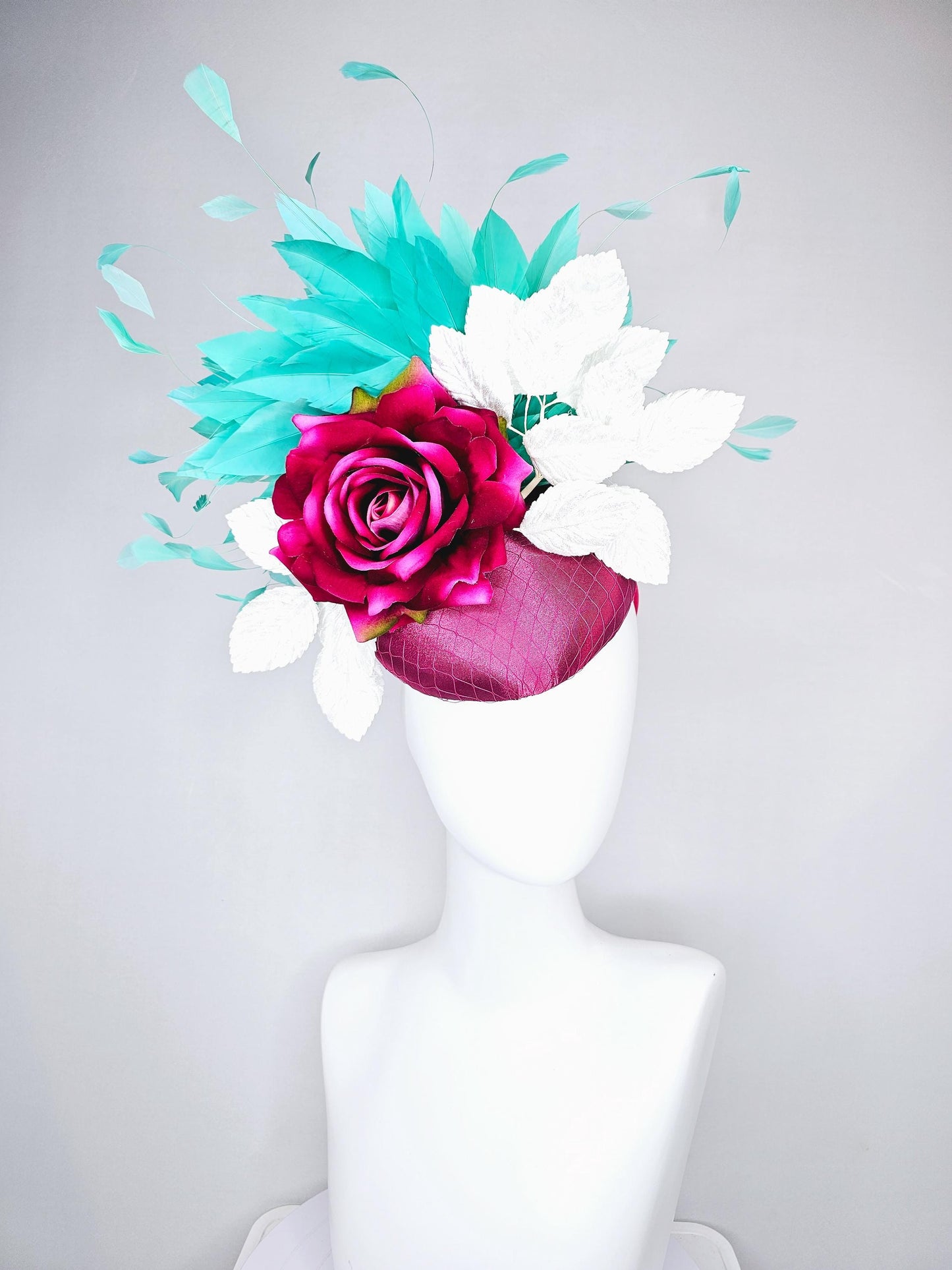 kentucky derby hat fascinator hot pink satin with netting,hot pink fuchsia satin silk rose flower,white leaves,aqua blue branching feathers