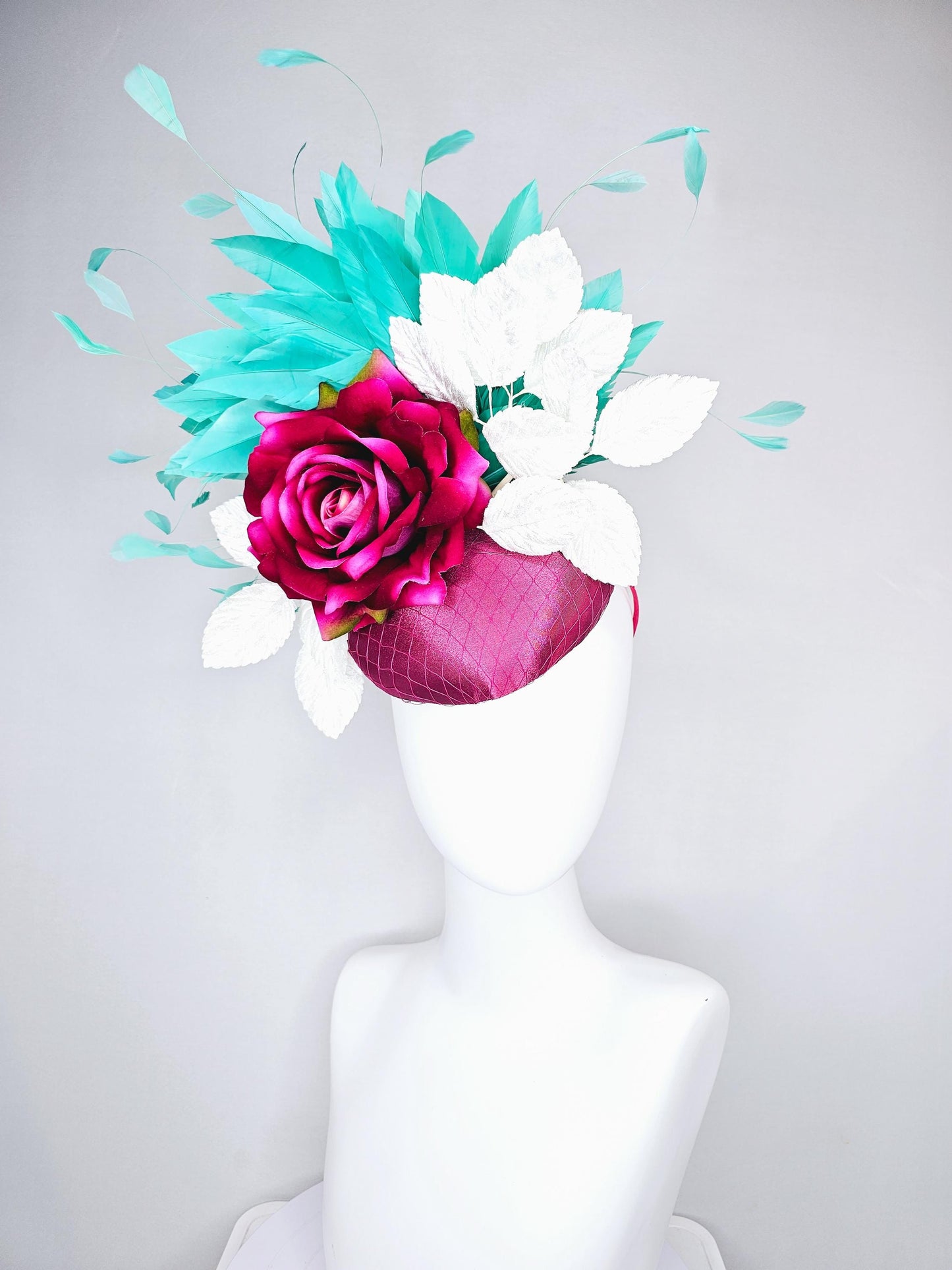 kentucky derby hat fascinator hot pink satin with netting,hot pink fuchsia satin silk rose flower,white leaves,aqua blue branching feathers