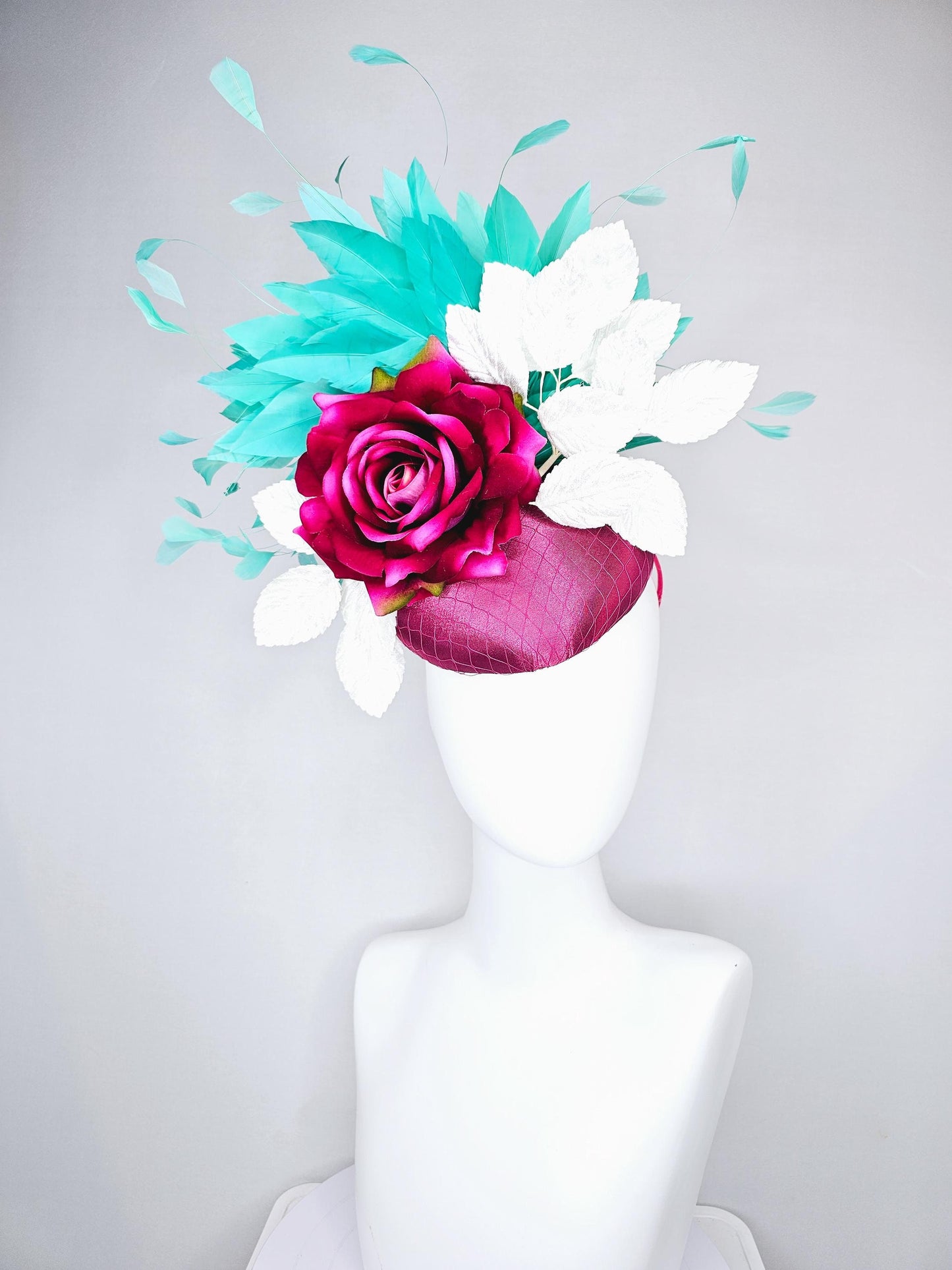 kentucky derby hat fascinator hot pink satin with netting,hot pink fuchsia satin silk rose flower,white leaves,aqua blue branching feathers