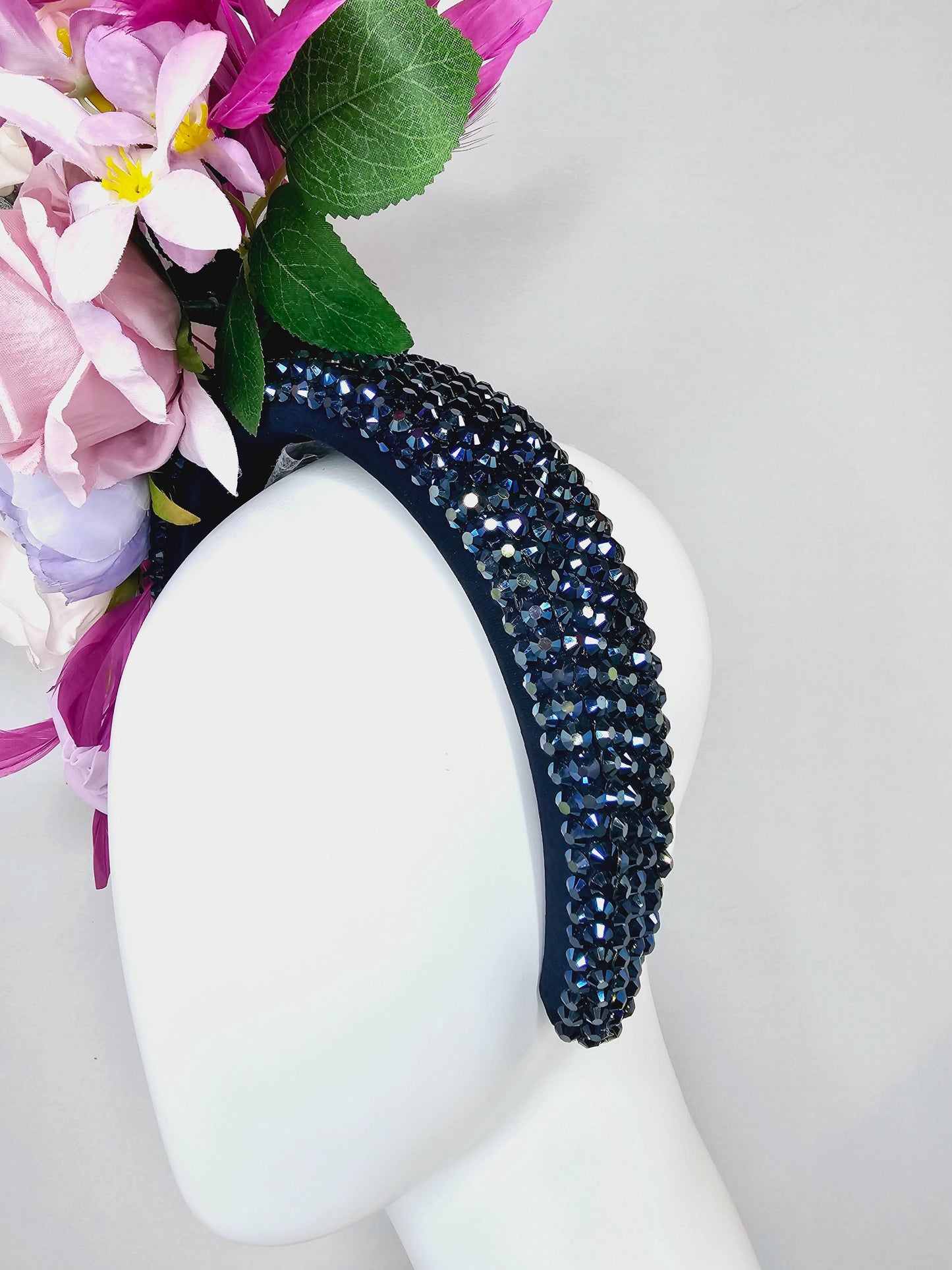 kentucky derby hat fascinator iridescent navy blue crystal headband,cream light pink purple lavender flowers,green leaves,magenta feathers