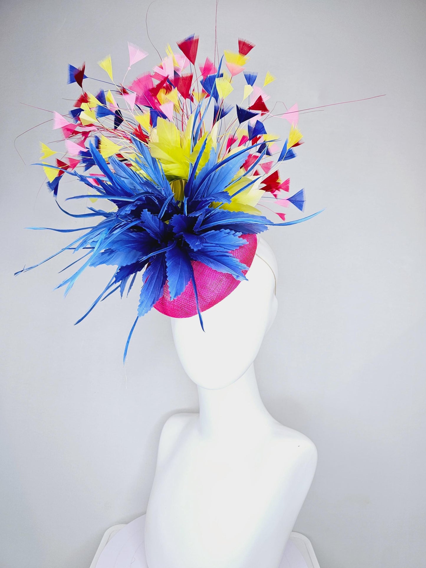 kentucky derby hat fascinator hot pink sinamay with large royal blue feather flower,branching colorful rainbow yellow,blue,red,pink feathers