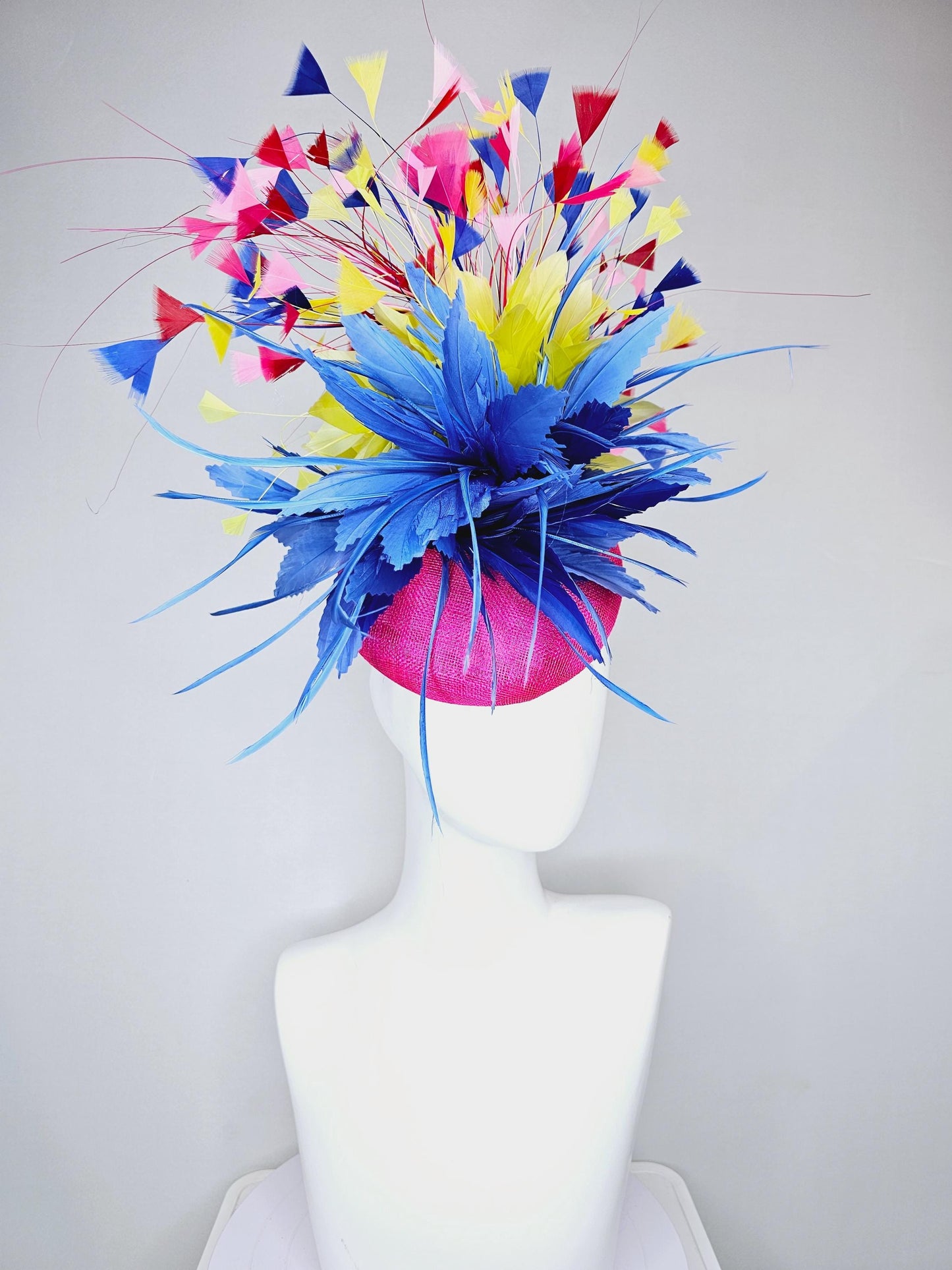 kentucky derby hat fascinator hot pink sinamay with large royal blue feather flower,branching colorful rainbow yellow,blue,red,pink feathers