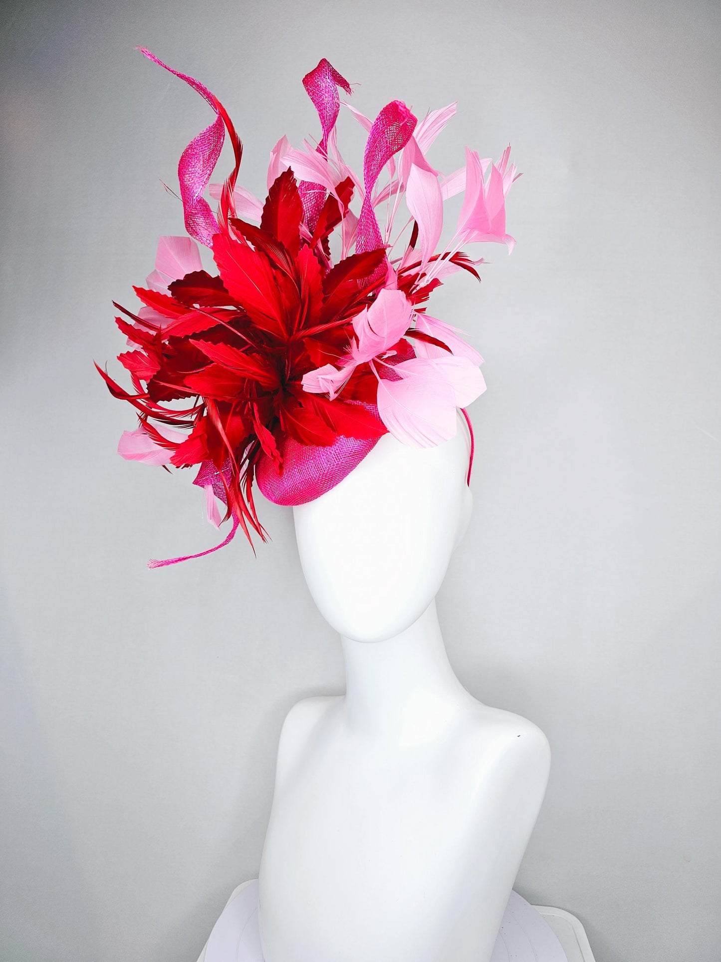 kentucky derby hat fascinator pink sinamay with large curls,bright red feathers and light pink branching feathers