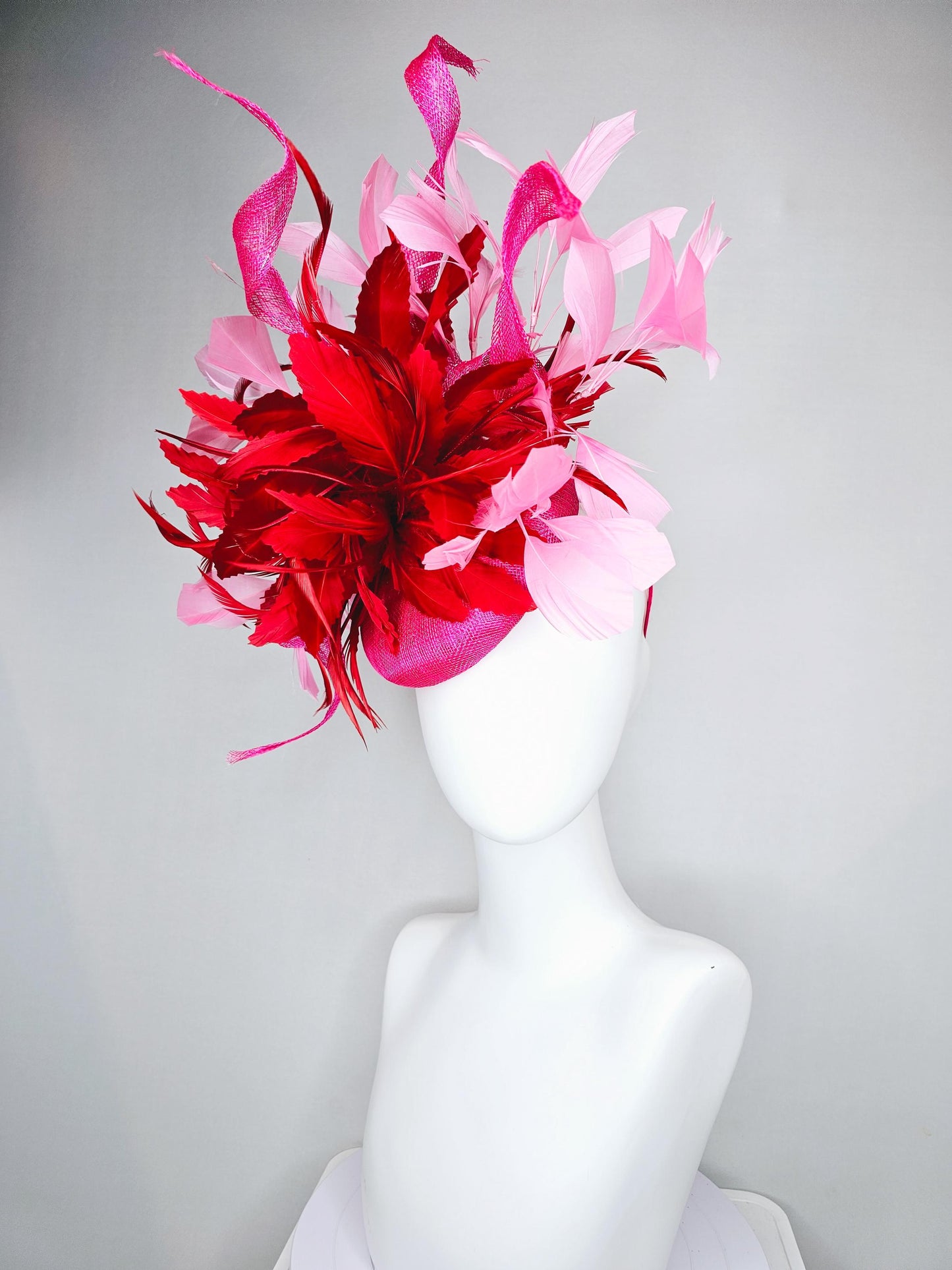 kentucky derby hat fascinator pink sinamay with large curls,bright red feathers and light pink branching feathers