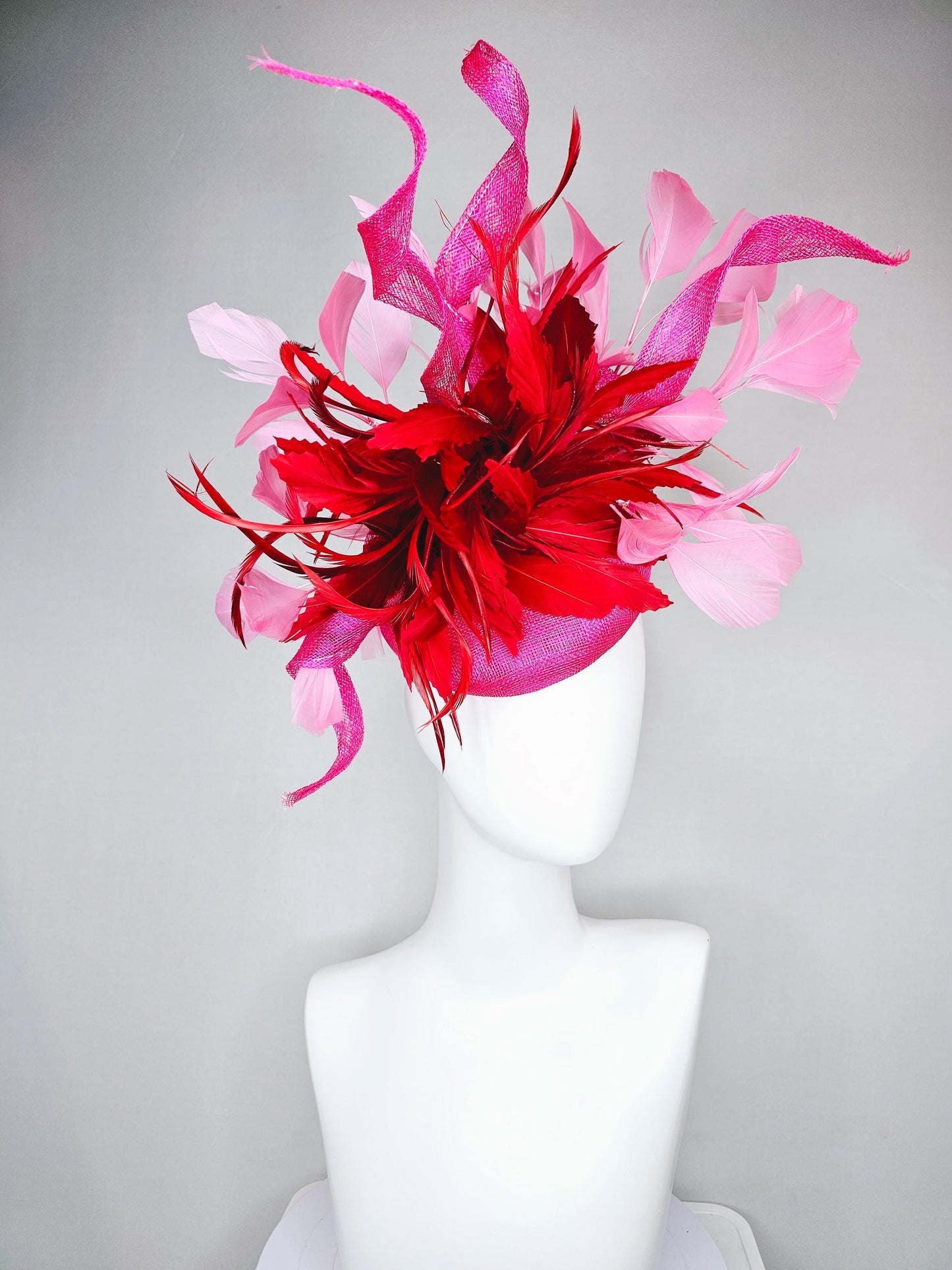 kentucky derby hat fascinator pink sinamay with large curls,bright red feathers and light pink branching feathers