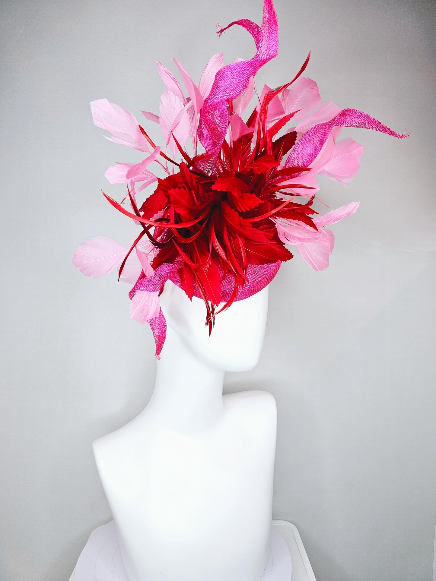 kentucky derby hat fascinator pink sinamay with large curls,bright red feathers and light pink branching feathers