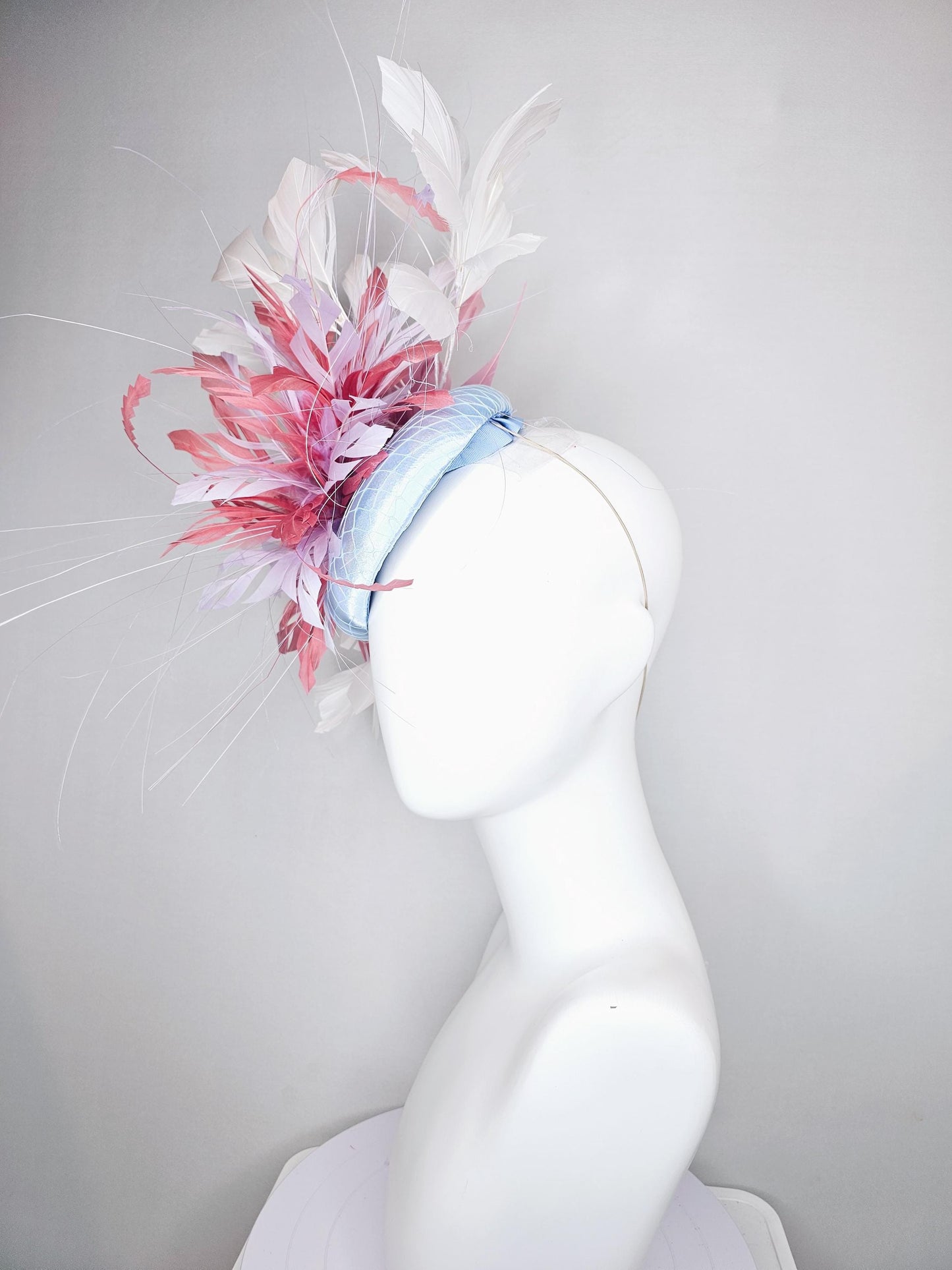 kentucky derby hat fascinator light baby blue satin with netting with blush pink,white,and light purple branching feathers