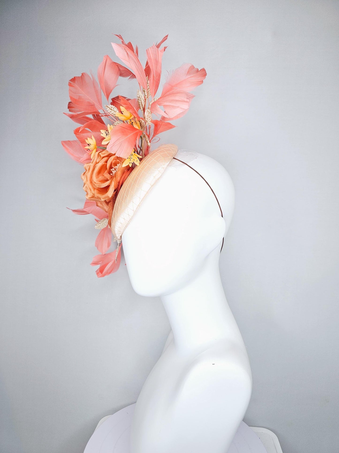 kentucky derby hat fascinator champagne satin with netting,orange satin flowers,yellow floral stems,coral orange feathers and gold leaves