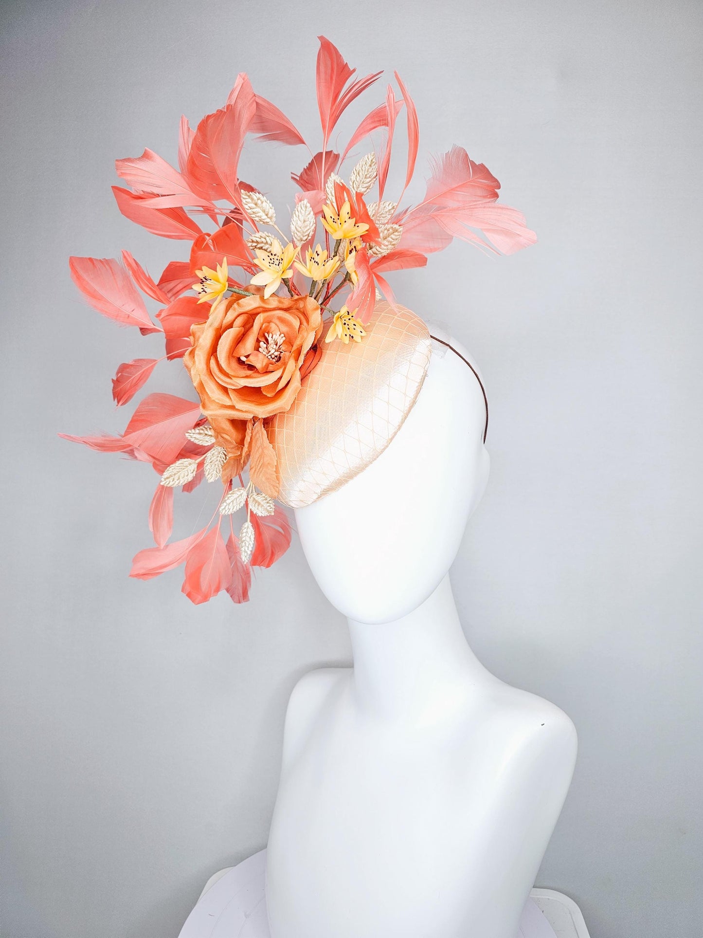 kentucky derby hat fascinator champagne satin with netting,orange satin flowers,yellow floral stems,coral orange feathers and gold leaves