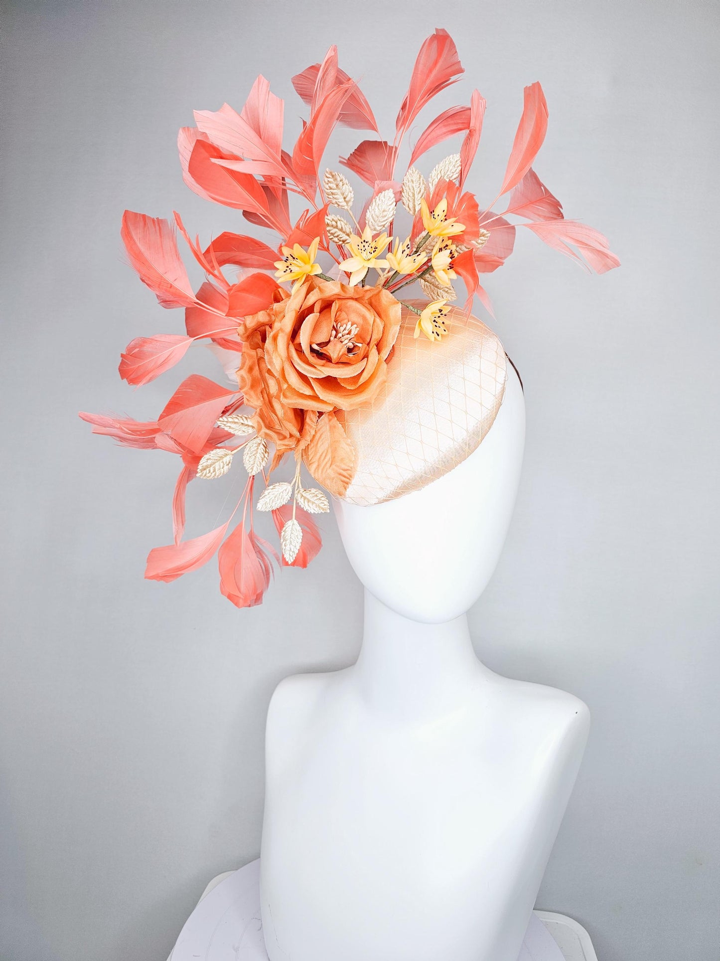 kentucky derby hat fascinator champagne satin with netting,orange satin flowers,yellow floral stems,coral orange feathers and gold leaves