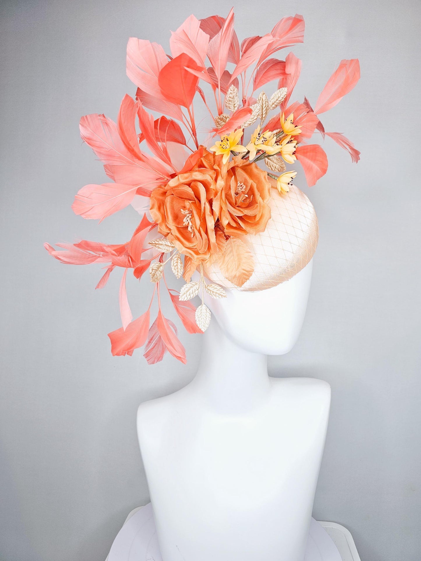 kentucky derby hat fascinator champagne satin with netting,orange satin flowers,yellow floral stems,coral orange feathers and gold leaves