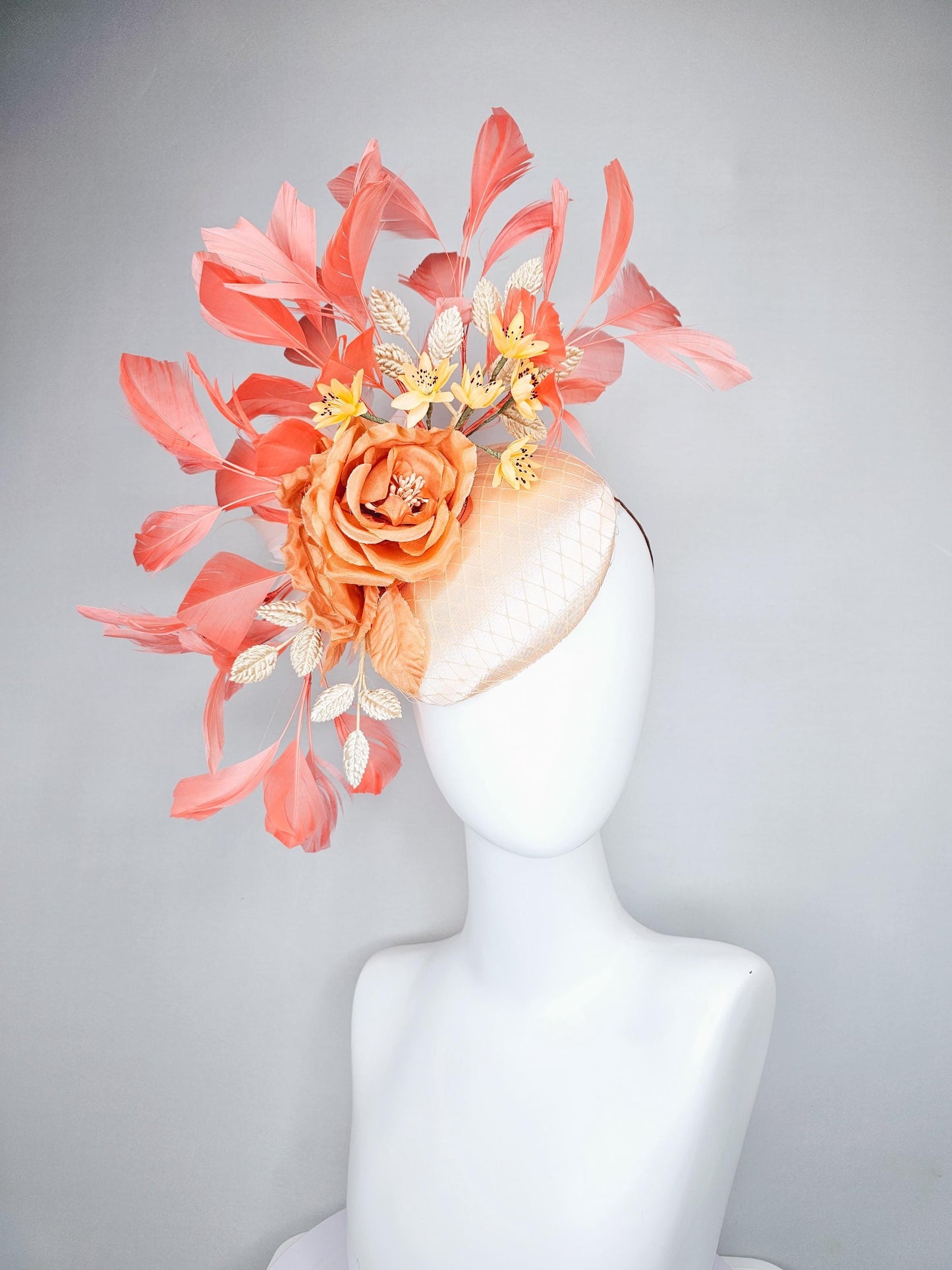 kentucky derby hat fascinator champagne satin with netting,orange satin flowers,yellow floral stems,coral orange feathers and gold leaves