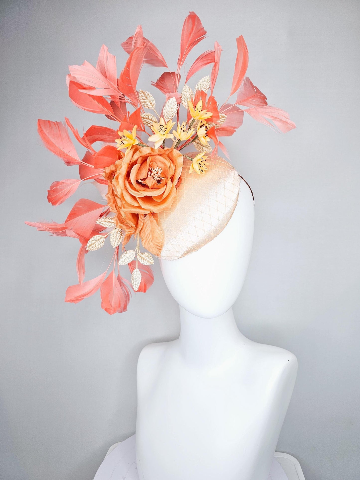 kentucky derby hat fascinator champagne satin with netting,orange satin flowers,yellow floral stems,coral orange feathers and gold leaves