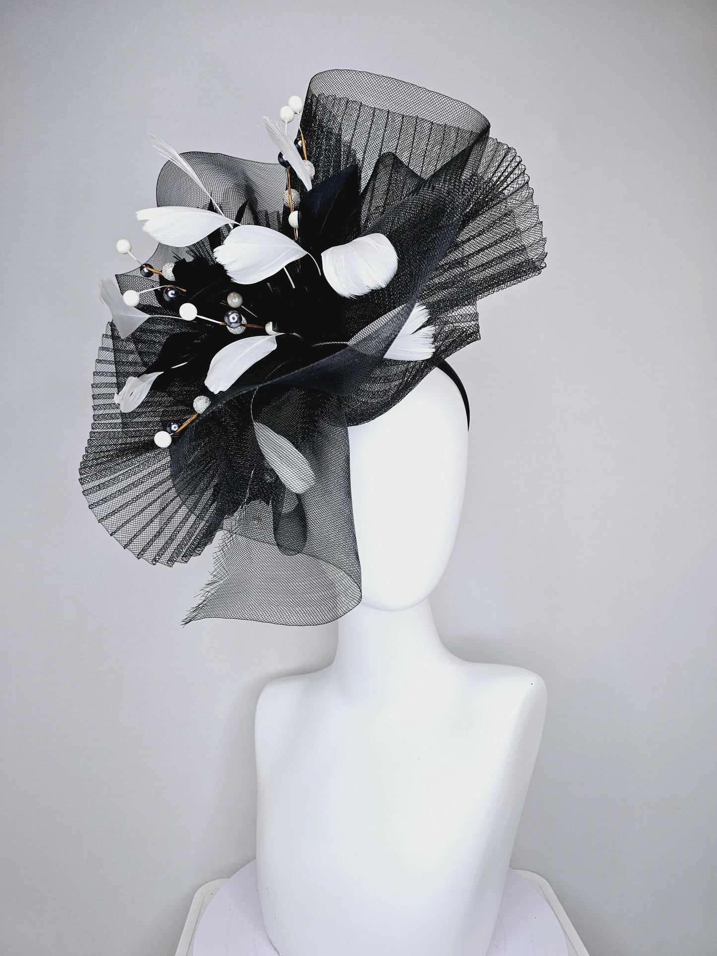 kentucky derby hat fascinator black pleated crinoline pouf with white and black feathers and branching white, sparkly, silver pearls