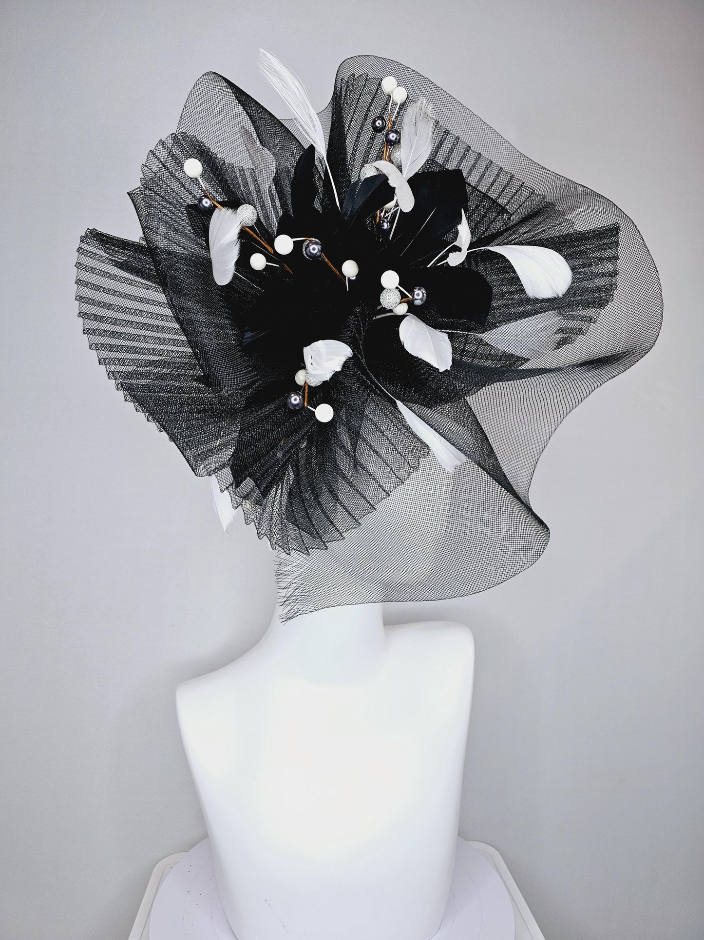 kentucky derby hat fascinator black pleated crinoline pouf with white and black feathers and branching white, sparkly, silver pearls