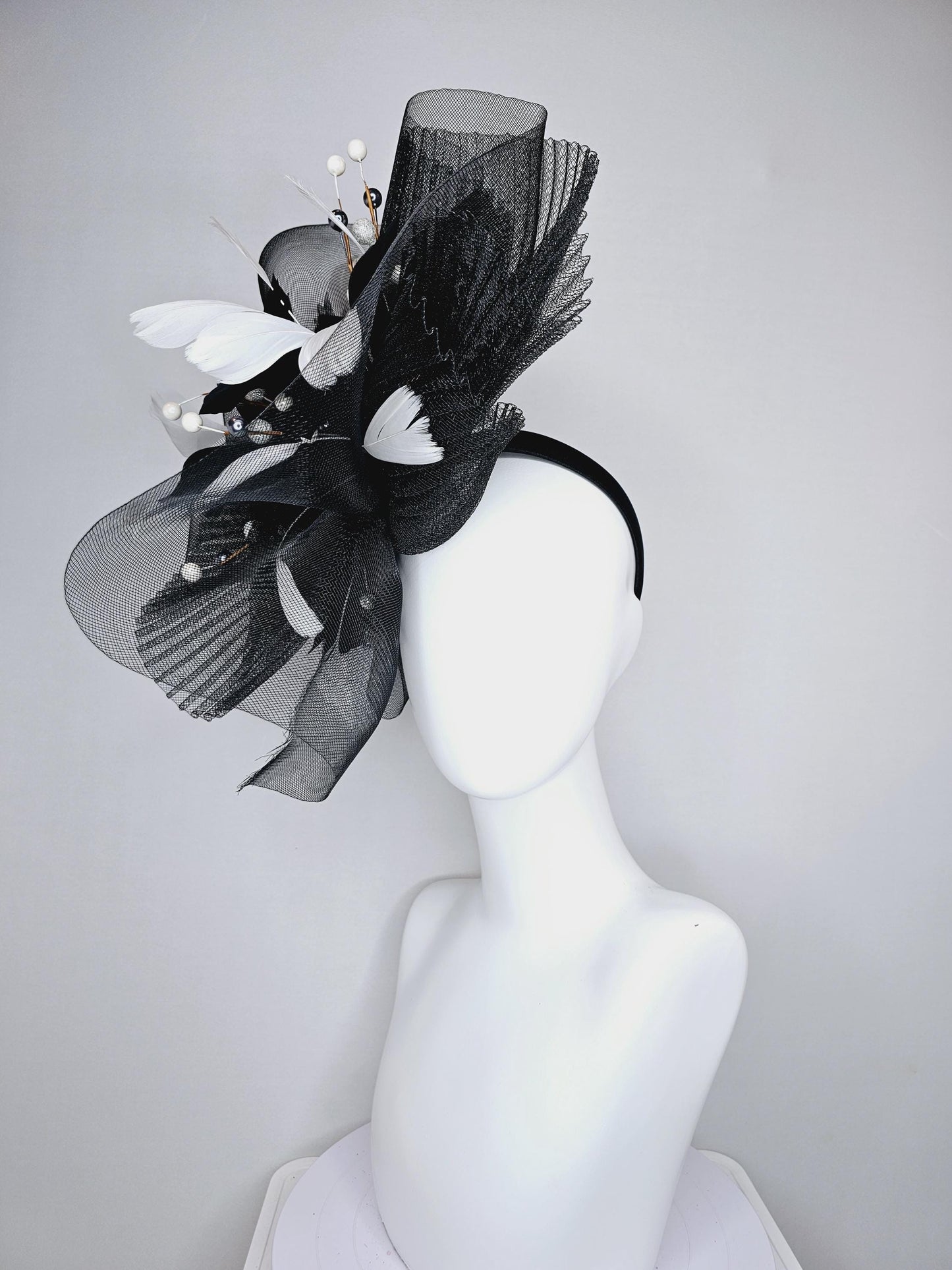 kentucky derby hat fascinator black pleated crinoline pouf with white and black feathers and branching white, sparkly, silver pearls