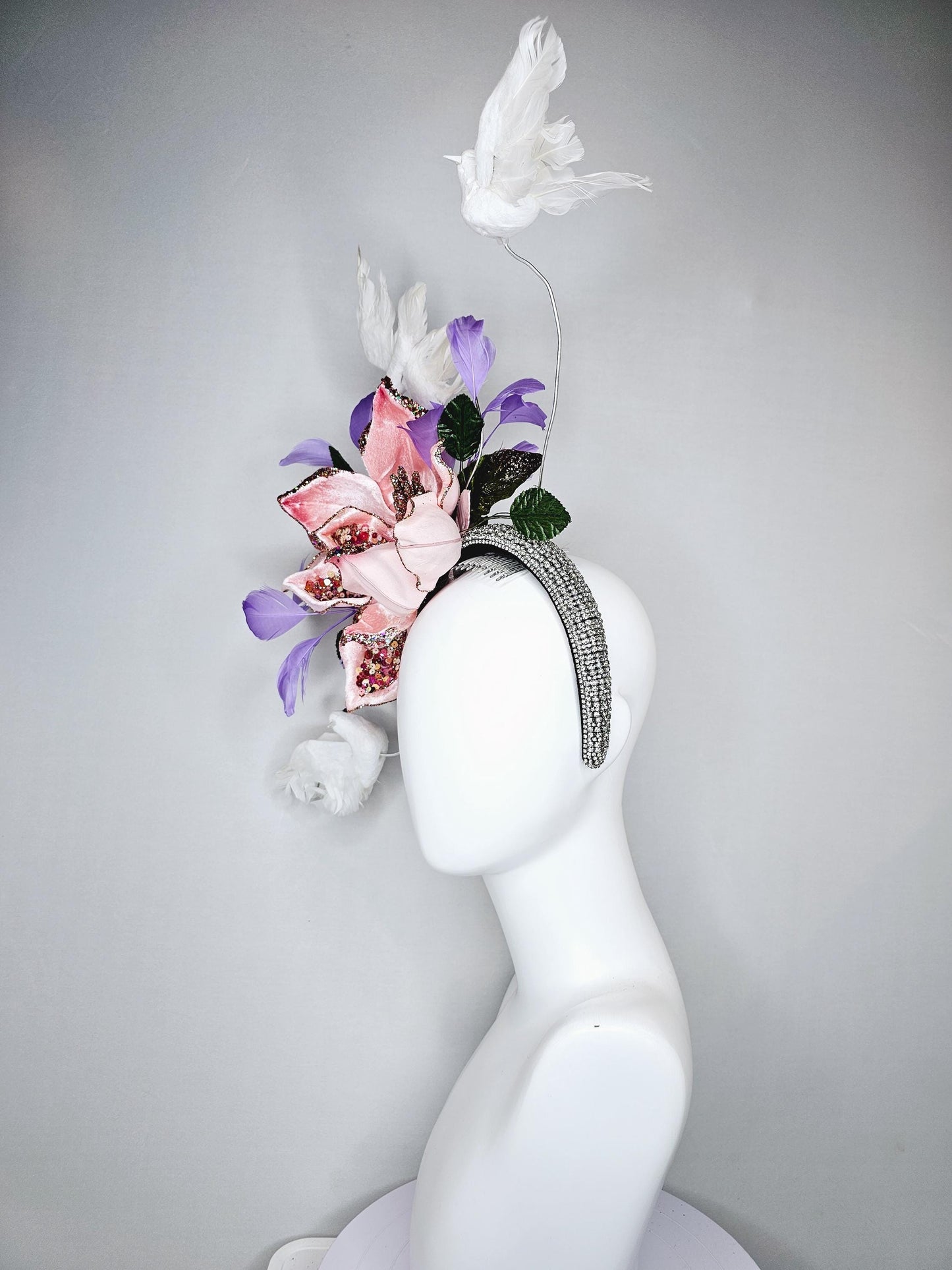 kentucky derby hat fascinator crystal rhinestone headband with light pink sparkle flower, purple lavender feathers and white feather birds