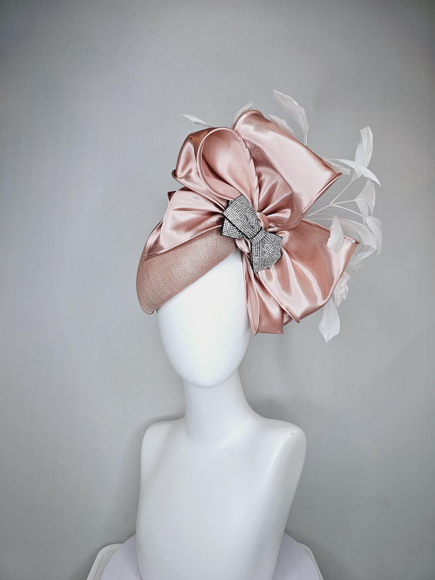 kentucky derby hat fascinator light dusty pink sinamay with satin champagne pink bow with Swarovski crystal bow and branching white feather