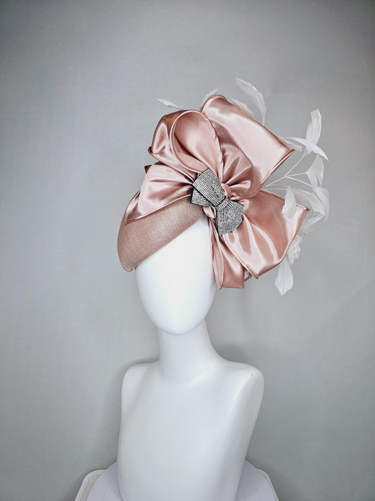 kentucky derby hat fascinator light dusty pink sinamay with satin champagne pink bow with Swarovski crystal bow and branching white feather