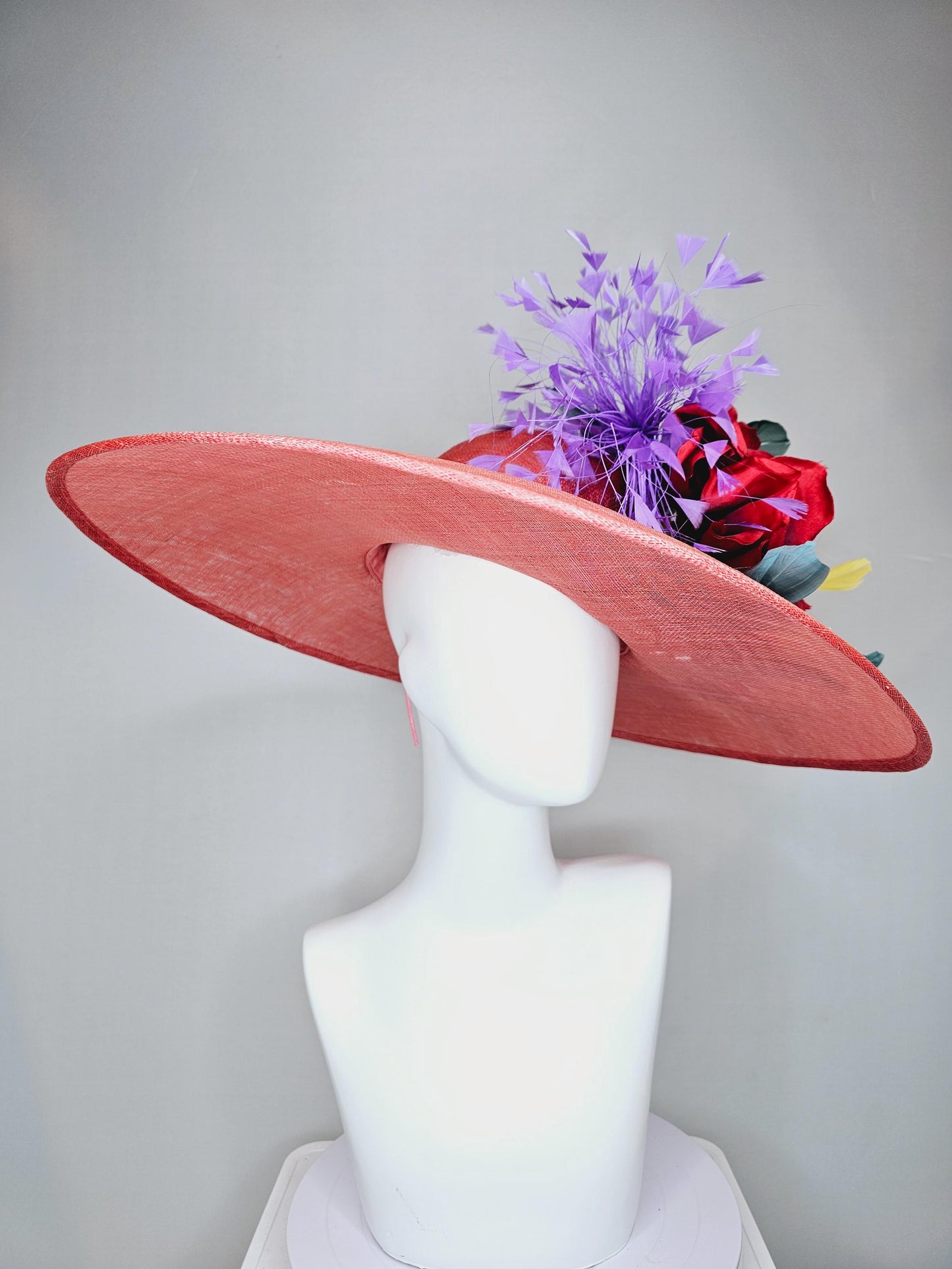 kentucky derby hat large wide brim sinamay coral orange hat with large red satin silk flower with purple,teal blue,yellow branching feathers