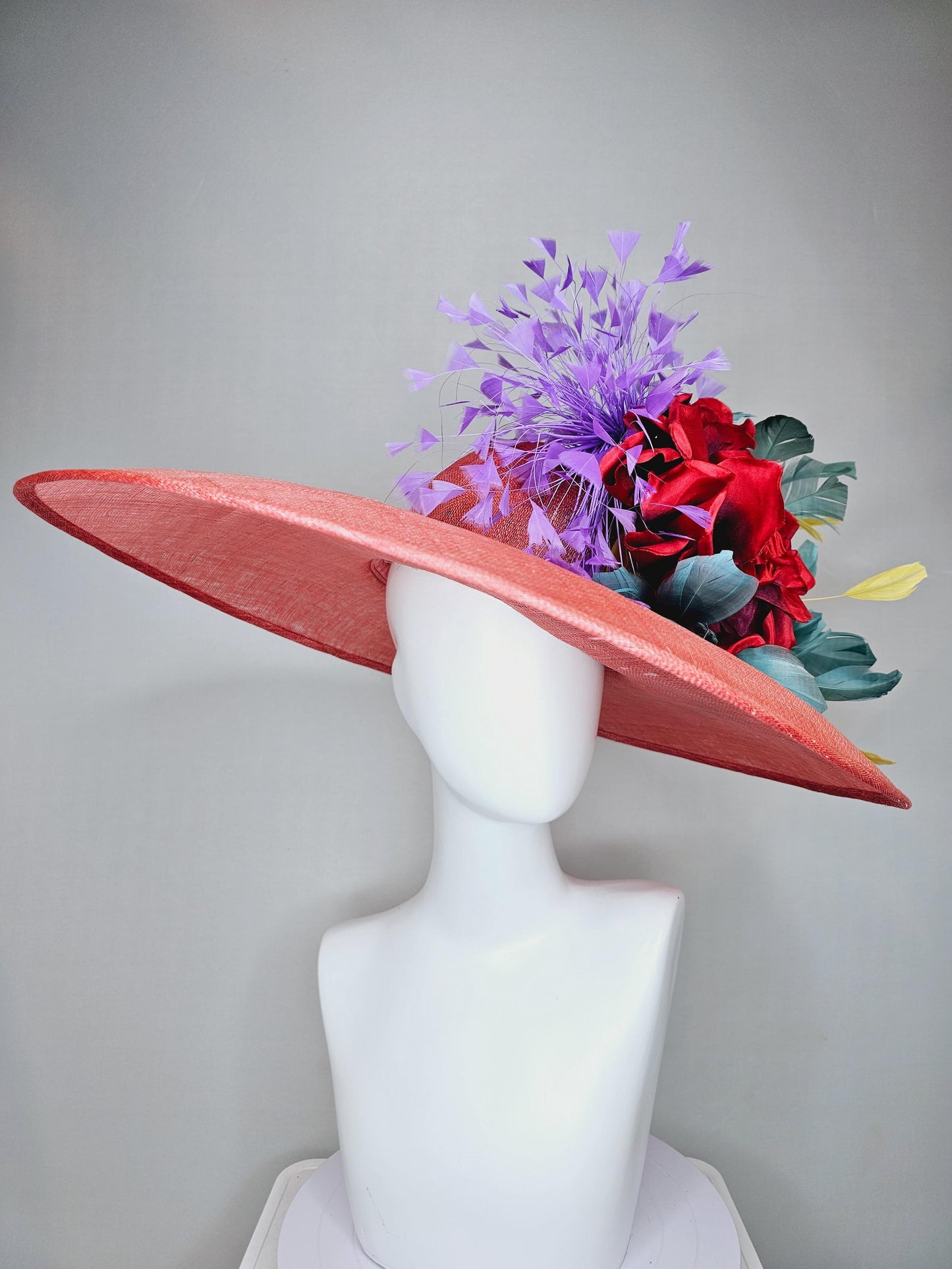 kentucky derby hat large wide brim sinamay coral orange hat with large red satin silk flower with purple,teal blue,yellow branching feathers