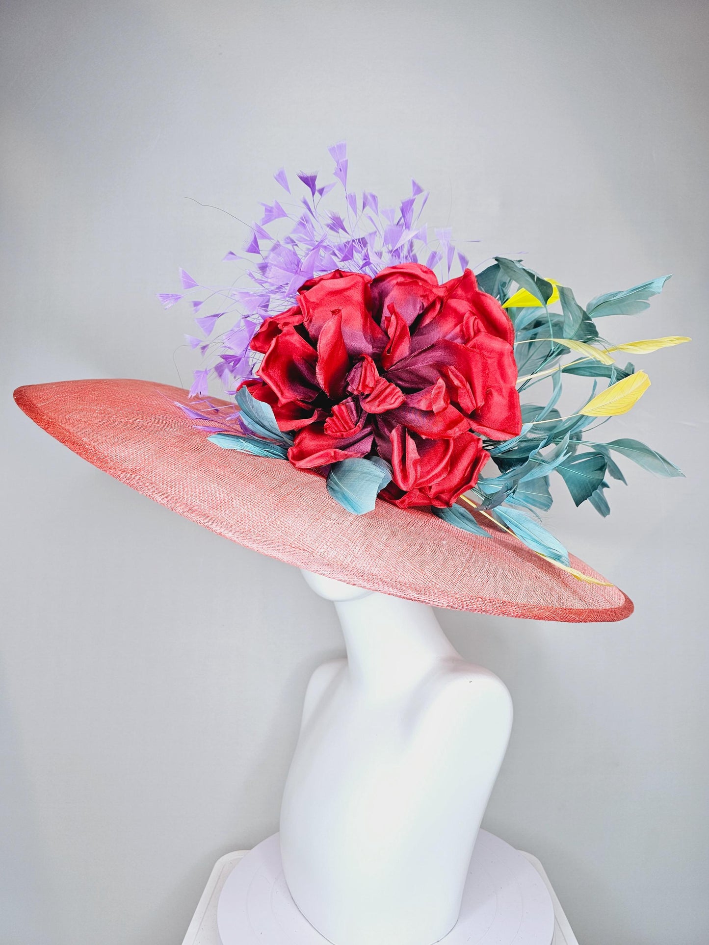 kentucky derby hat large wide brim sinamay coral orange hat with large red satin silk flower with purple,teal blue,yellow branching feathers