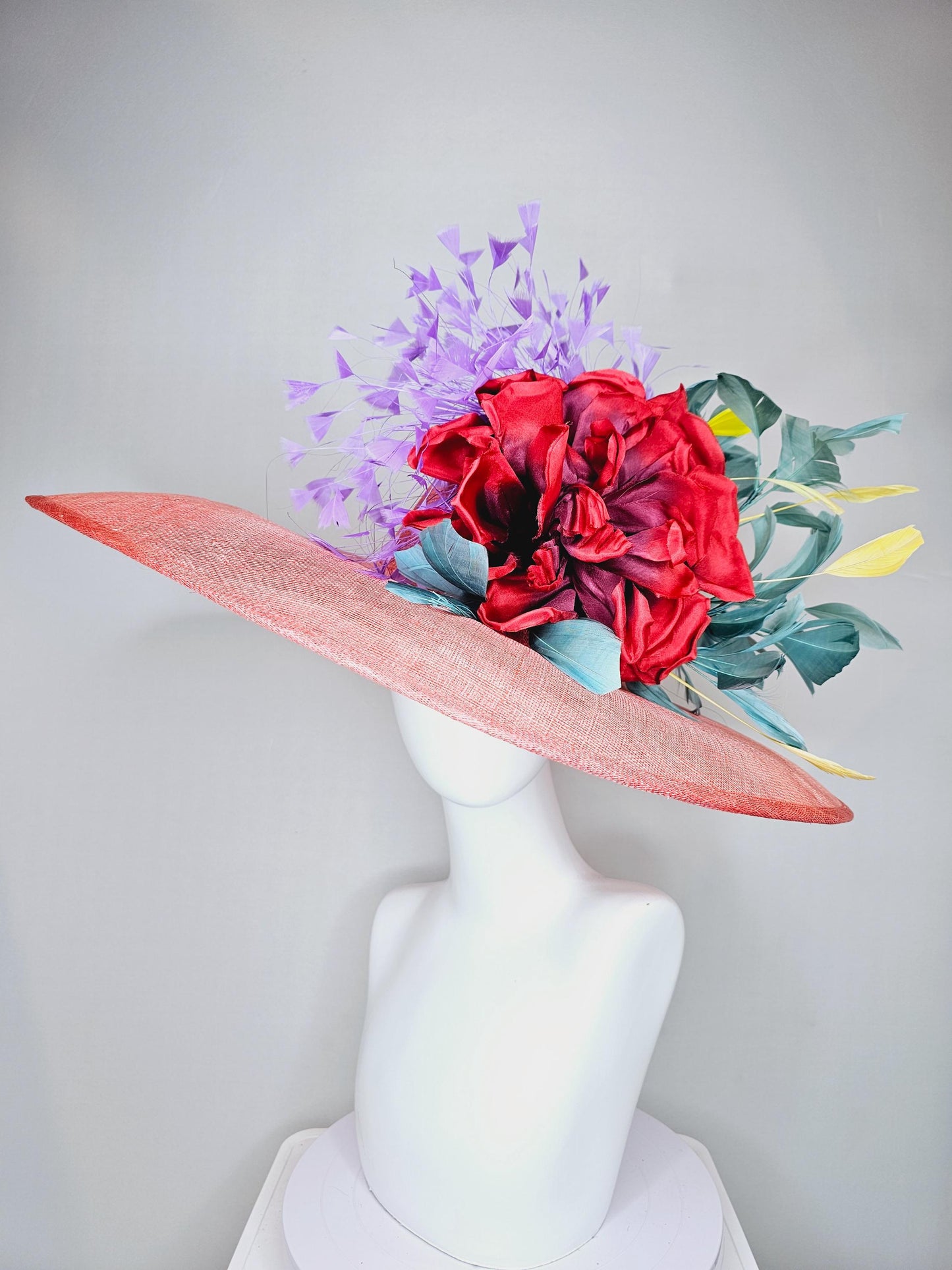 kentucky derby hat large wide brim sinamay coral orange hat with large red satin silk flower with purple,teal blue,yellow branching feathers