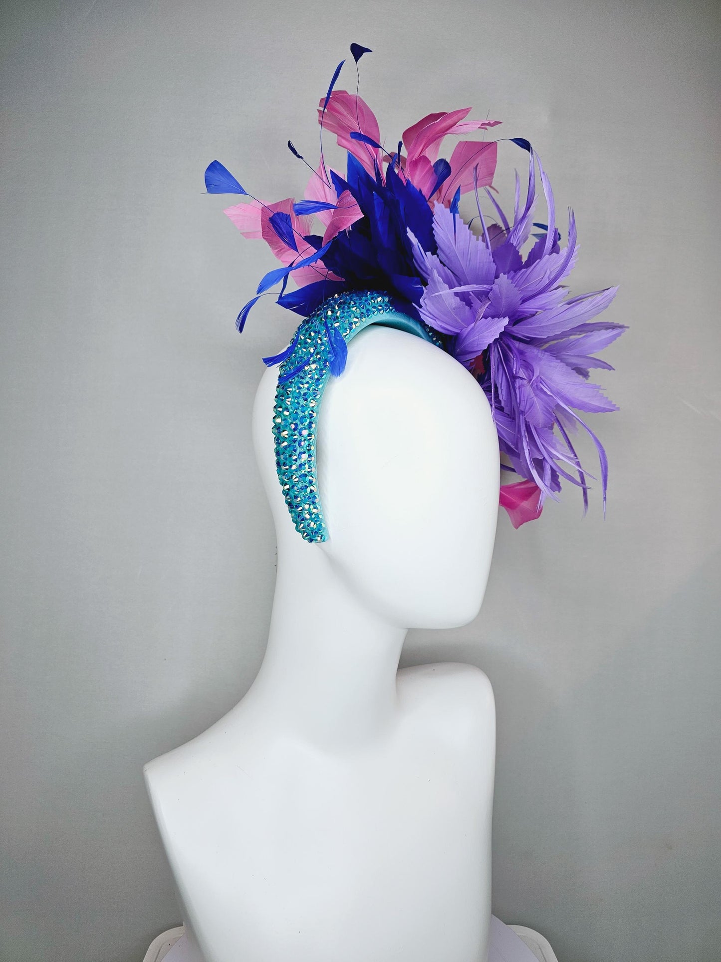 kentucky derby hat fascinator branching pink,royal blue,and purple lavender feathers on iridescent Swarovski crystal turquoise blue headband