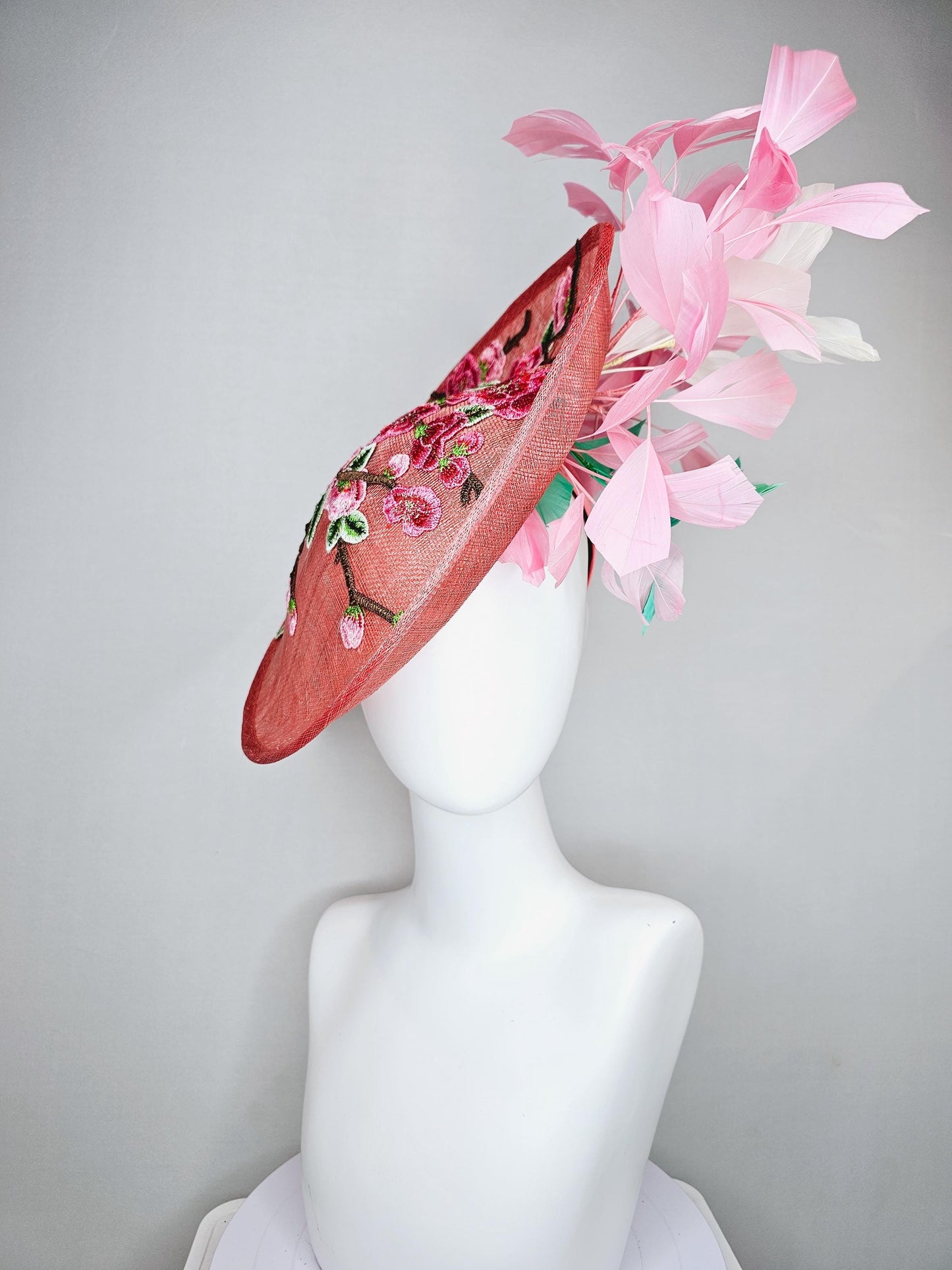 kentucky derby hat fascinator coral peach sinamay saucer with pink green brown floral embroidery,light pink and green branching feathers