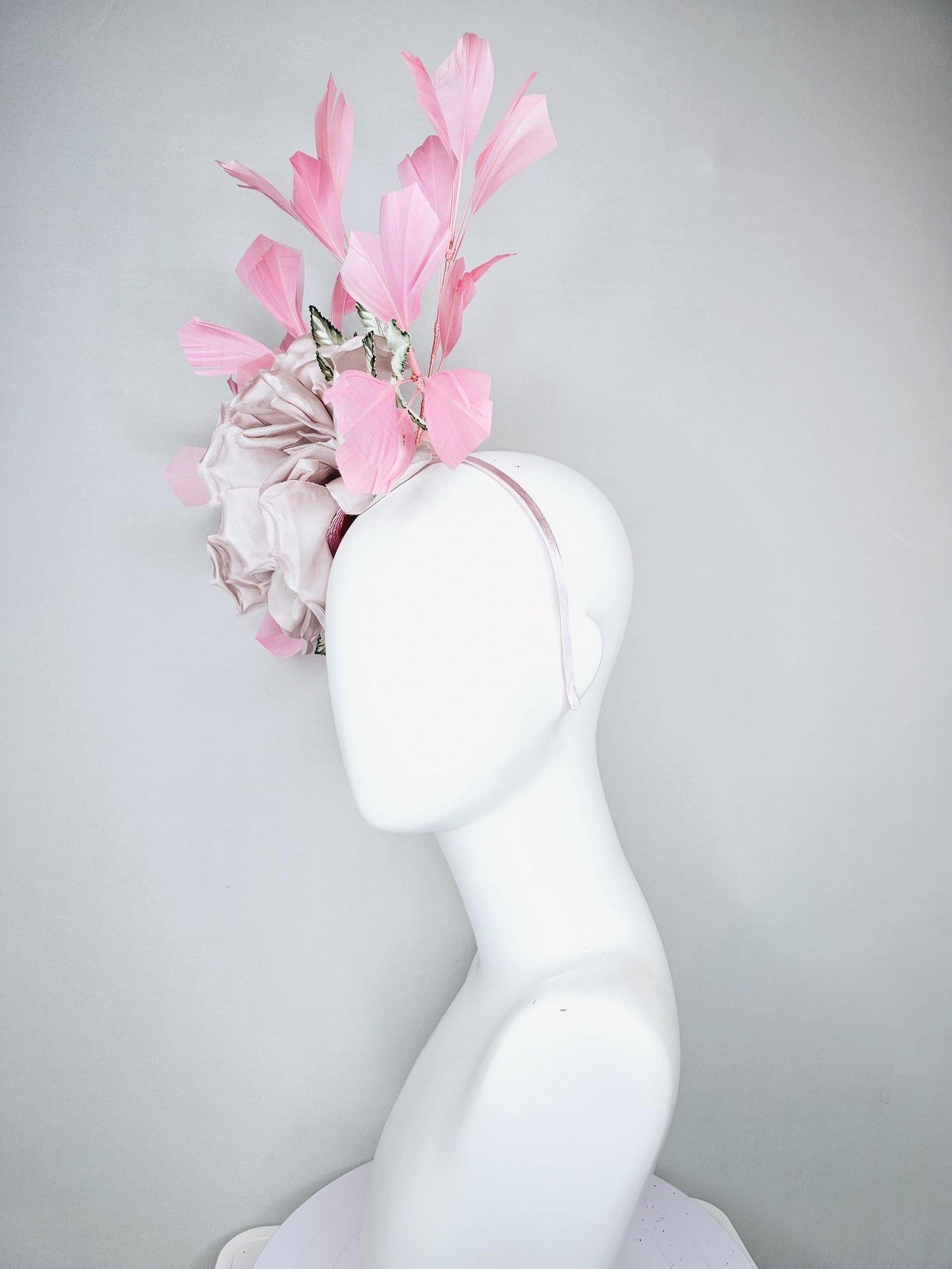 kentucky derby hat fascinator light dusty pink rose satin silk flower, white and green satin leaves and light baby pink branching feathers