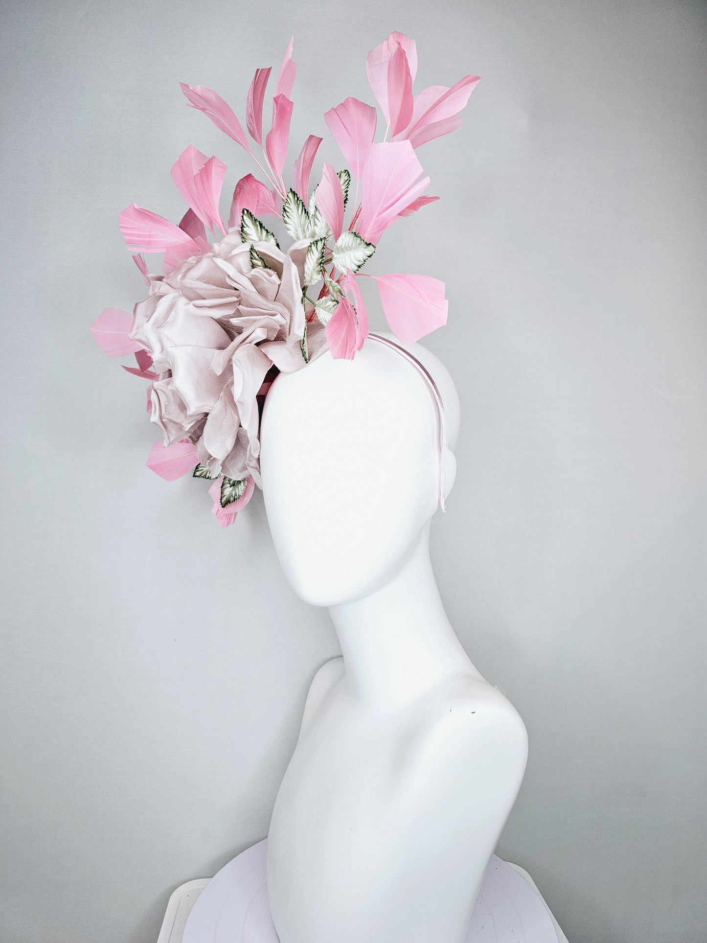 kentucky derby hat fascinator light dusty pink rose satin silk flower, white and green satin leaves and light baby pink branching feathers