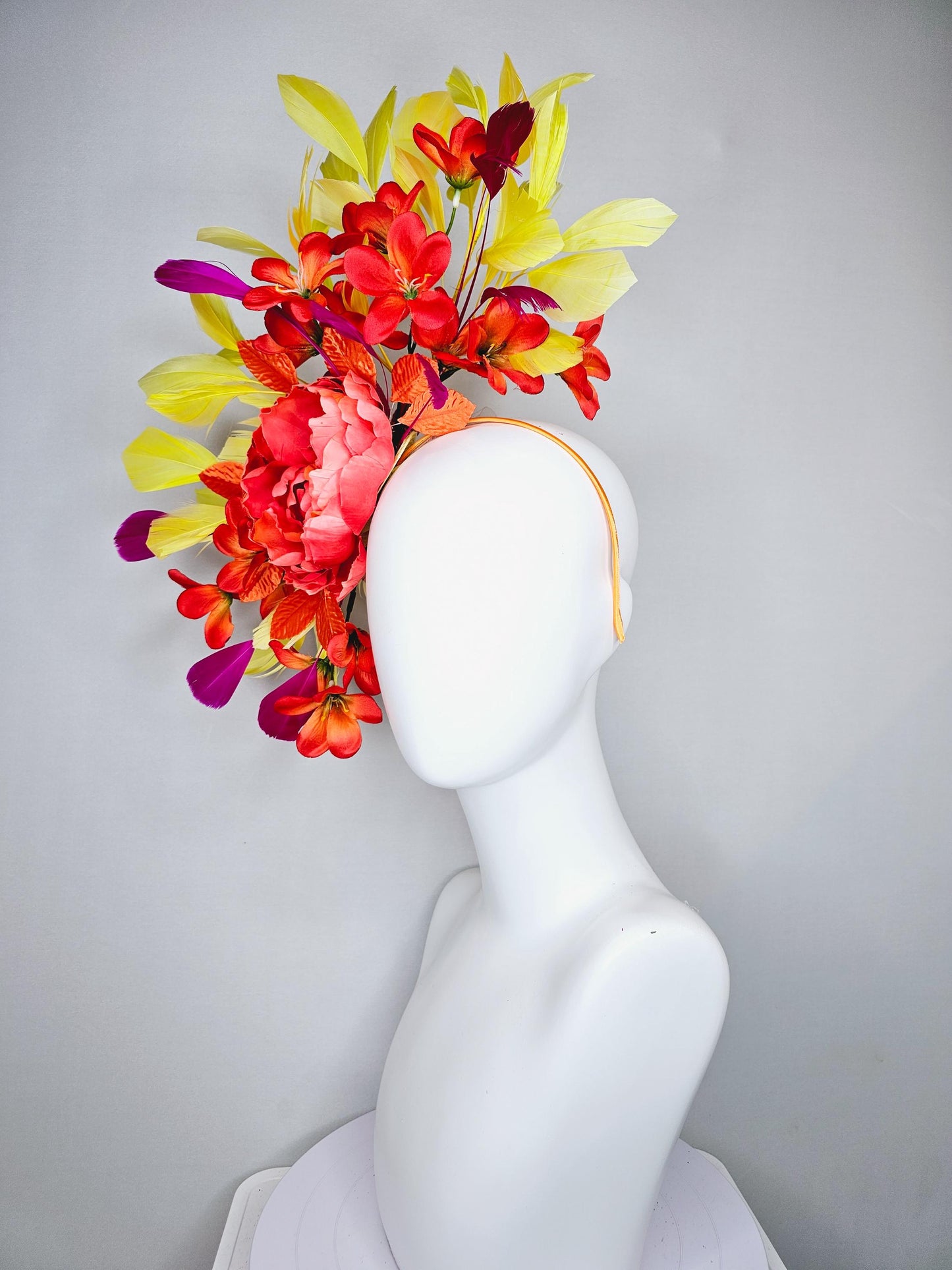 kentucky derby hat fascinator coral orange silk satin flowers with orange satin leaves, yellow and pink branching feathers on thin headband