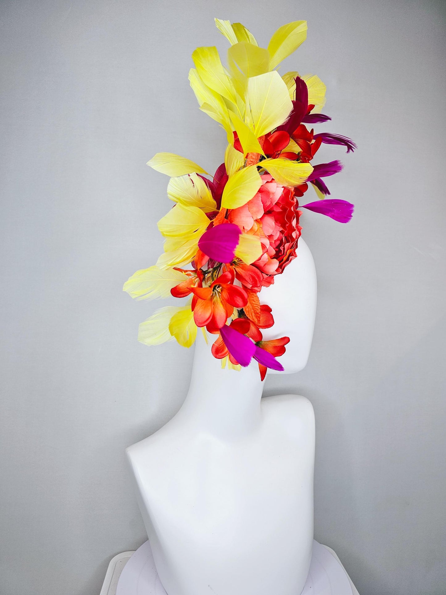 kentucky derby hat fascinator coral orange silk satin flowers with orange satin leaves, yellow and pink branching feathers on thin headband