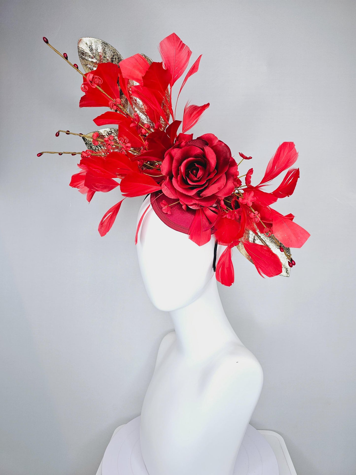 kentucky derby hat fascinator burgundy red satin with burgundy red satin rose flower, cherry red branching feathers, gold leaves and stems