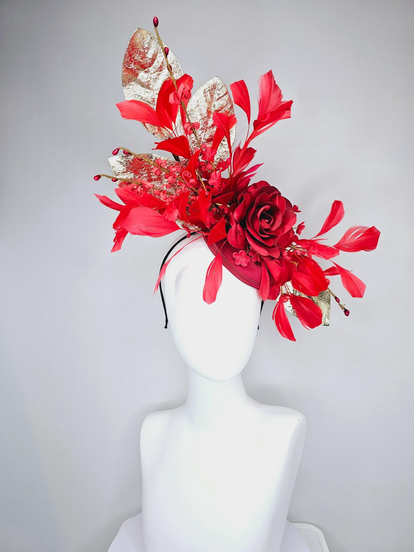 kentucky derby hat fascinator burgundy red satin with burgundy red satin rose flower, cherry red branching feathers, gold leaves and stems