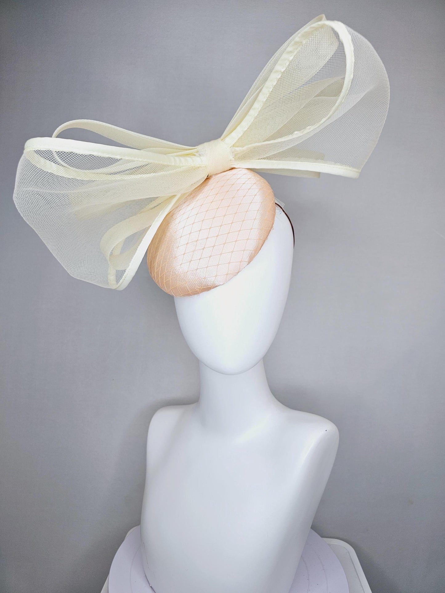 kentucky derby hat fascinator light pink satin with netting and large mesh neutral beige ivory bow