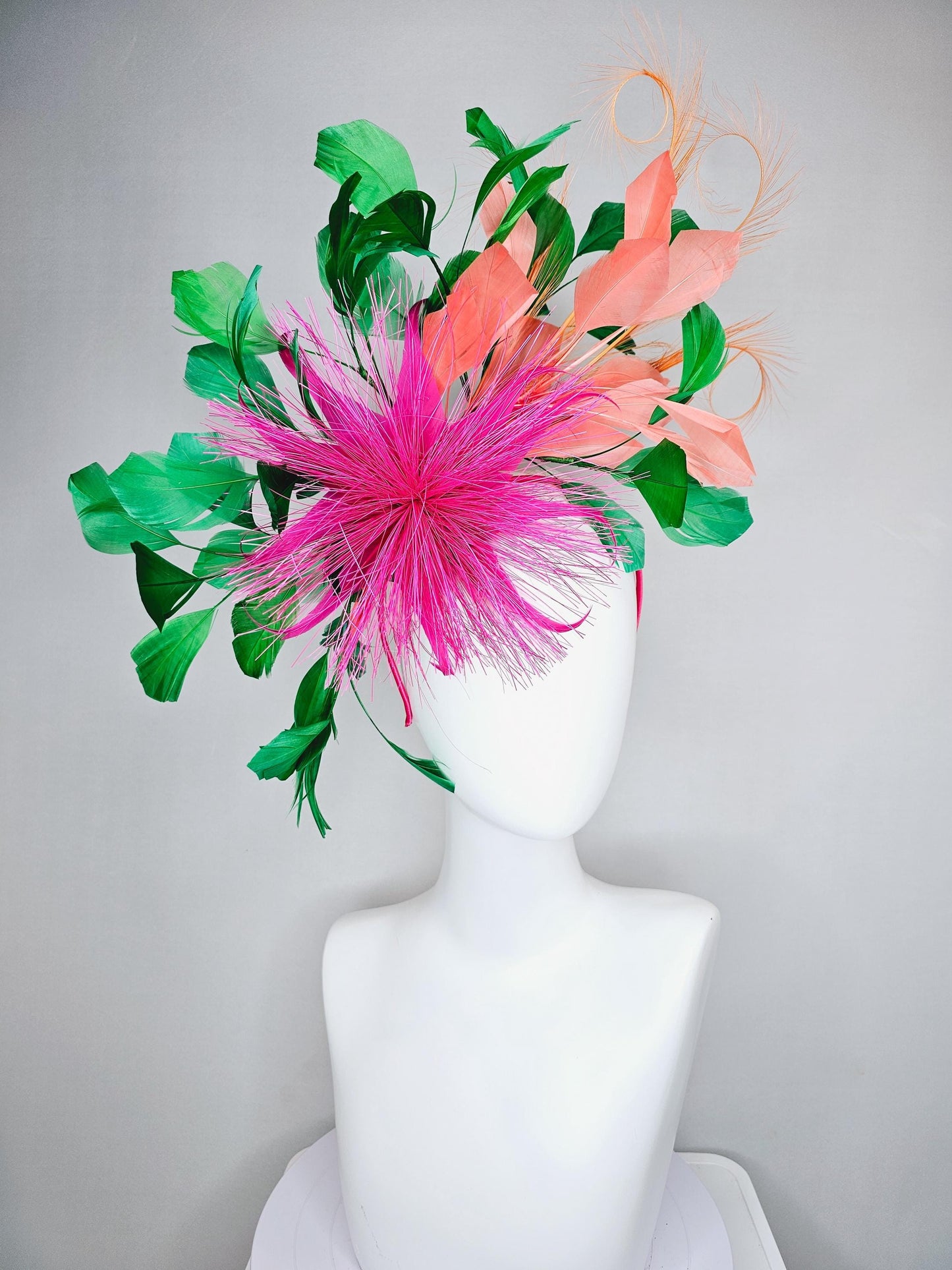 kentucky derby hat fascinator pink spiky feather flower, light orange peach, emerald green branching feathers and light peach feather curls