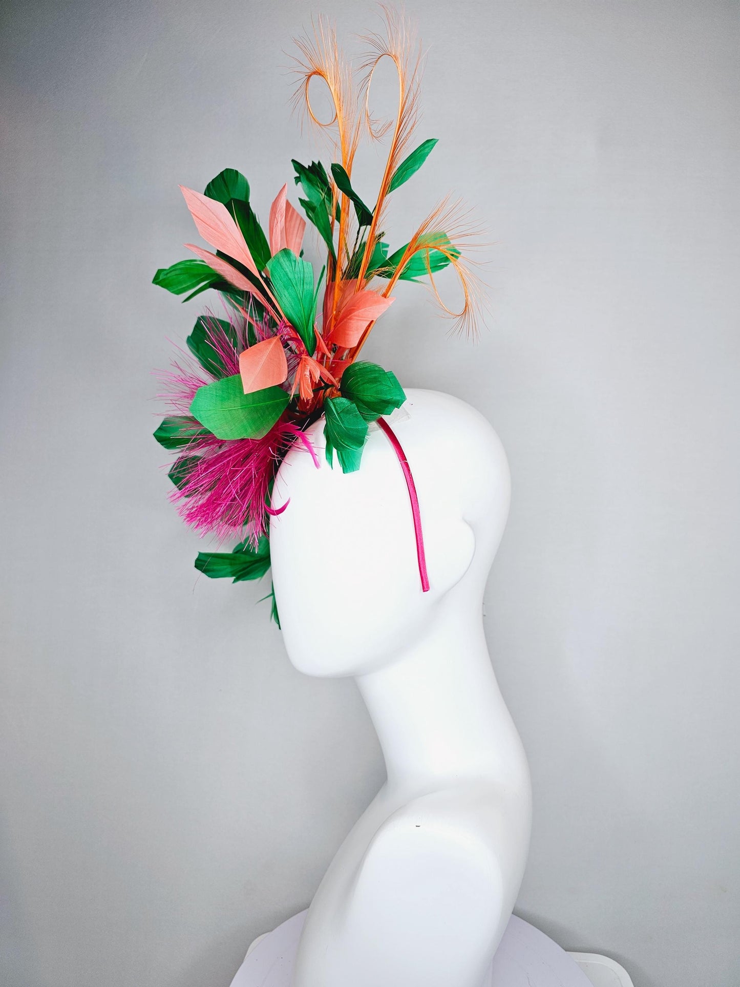 kentucky derby hat fascinator pink spiky feather flower, light orange peach, emerald green branching feathers and light peach feather curls