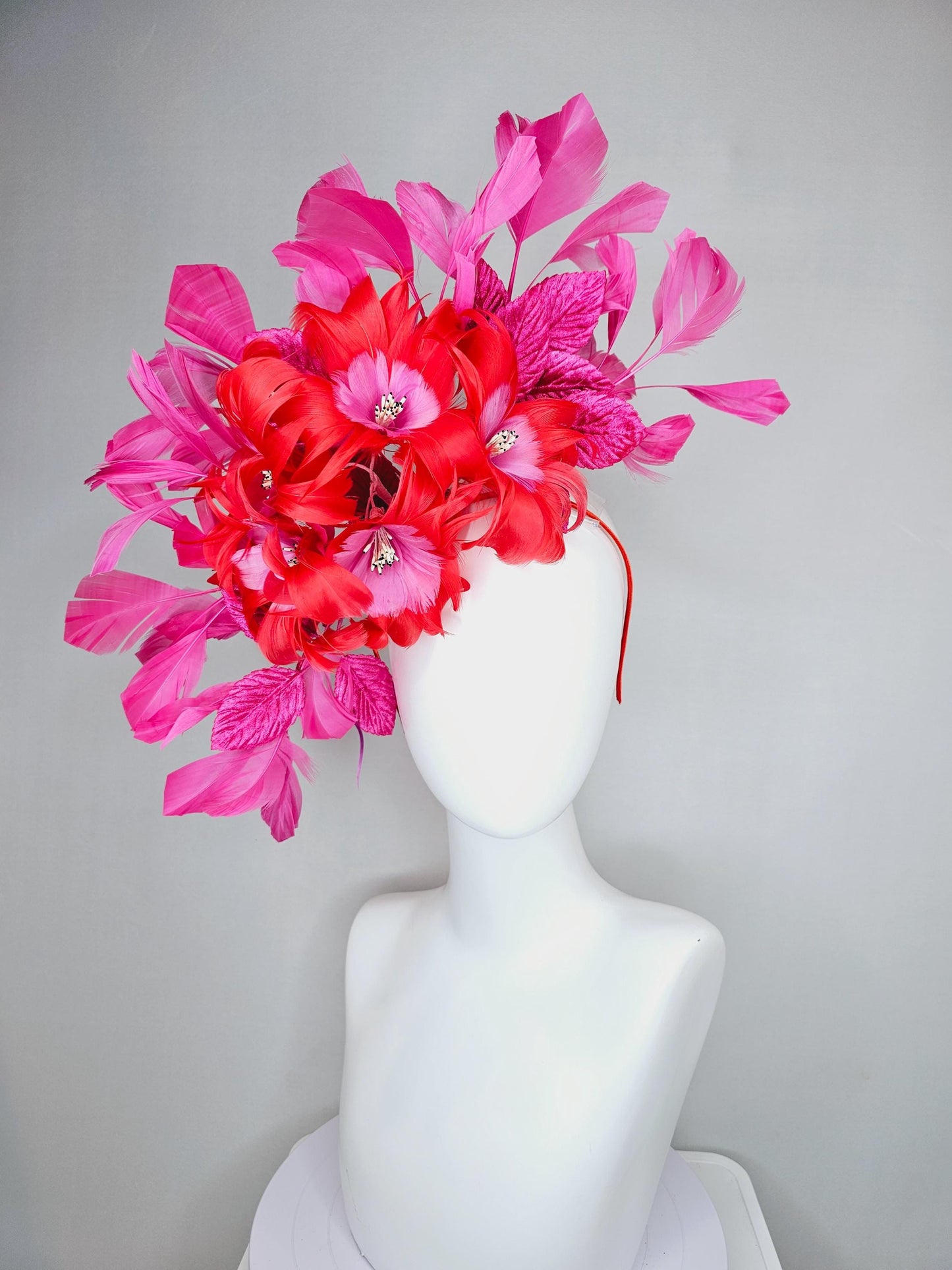 kentucky derby hat fascinator with cherry red feather flowers with blush pink feather cores, pink leaves and pink branching feathers